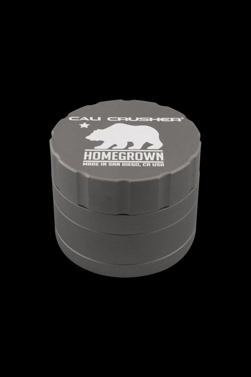 Top-down view of a gray Cali Crusher Homegrown 4 Piece Grinder with its white bear logo and text visible on the lid.