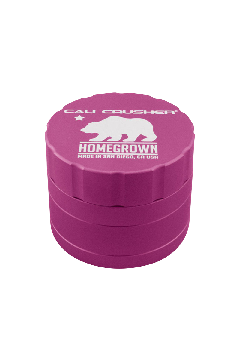 Top-down view of a magenta Cali Crusher Homegrown 4 Piece Grinder with white bear logo and ridged sides.