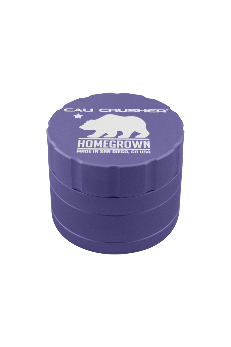 Angled top-down view of a purple Cali Crusher Homegrown 4 Piece Grinder with white bear logo and ridged sides.