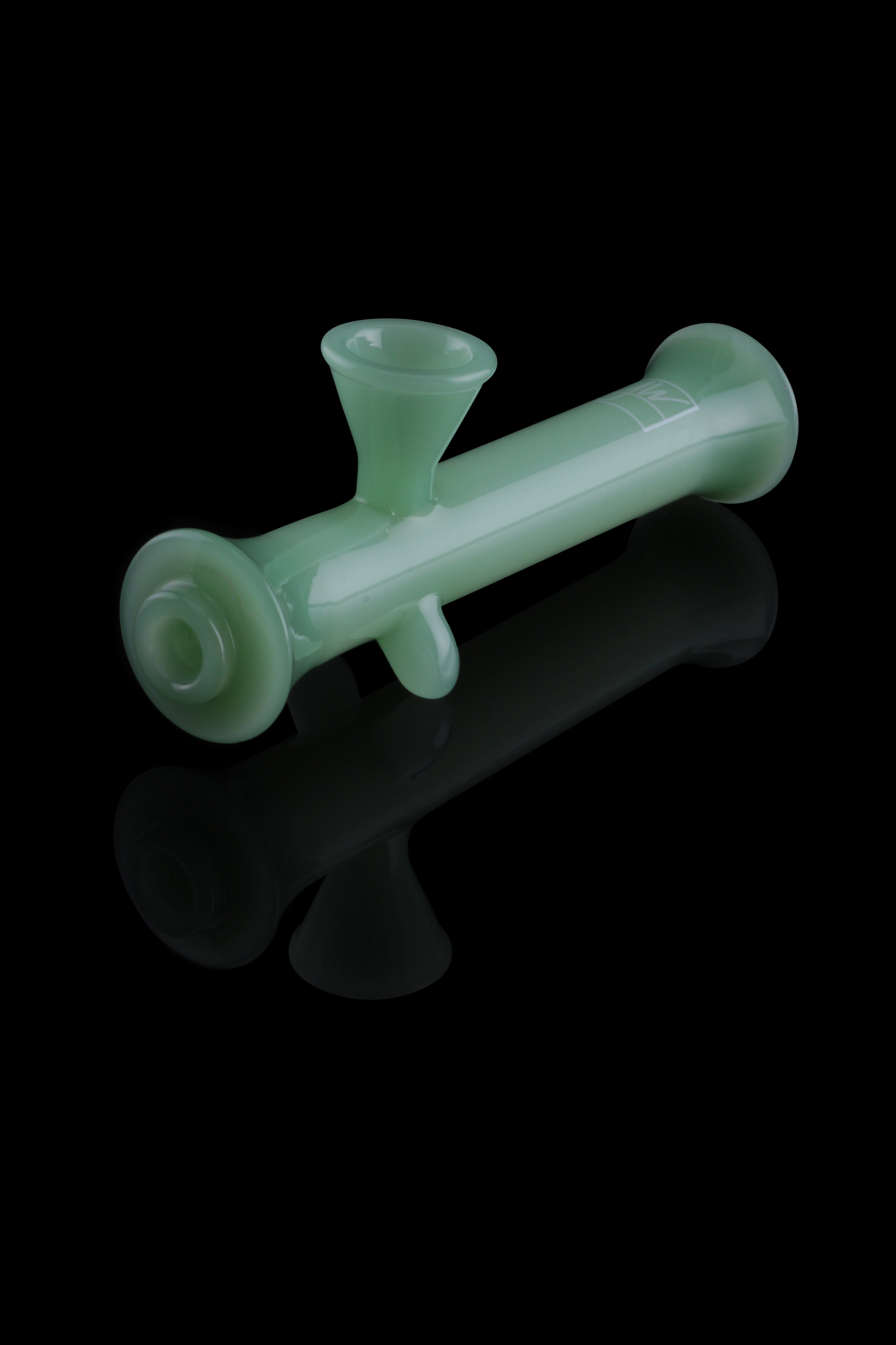 Green glass bubbler with a reflective surface.