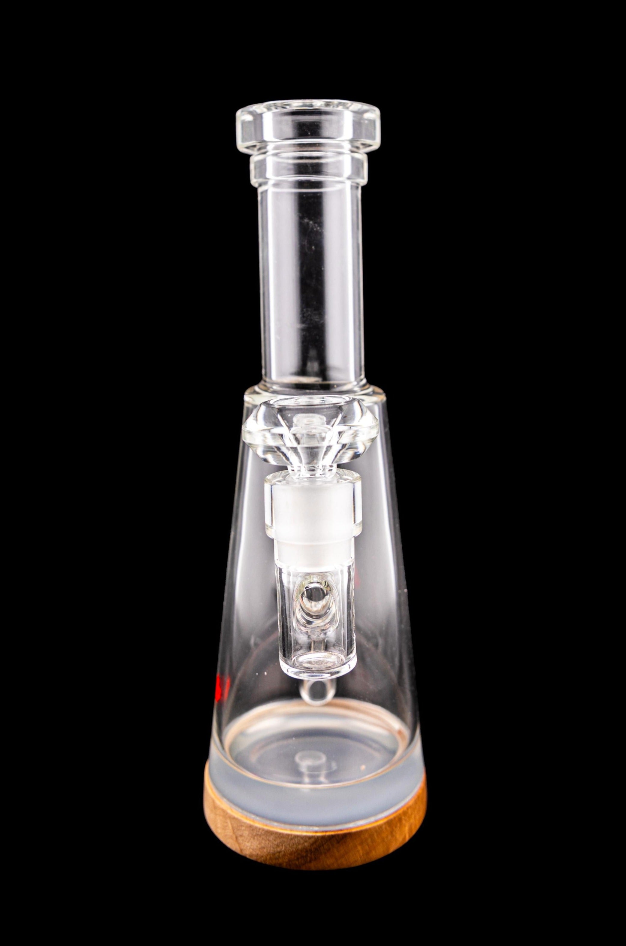 Clear glass water pipe (rig) with a wooden base, isolated on a black background.
