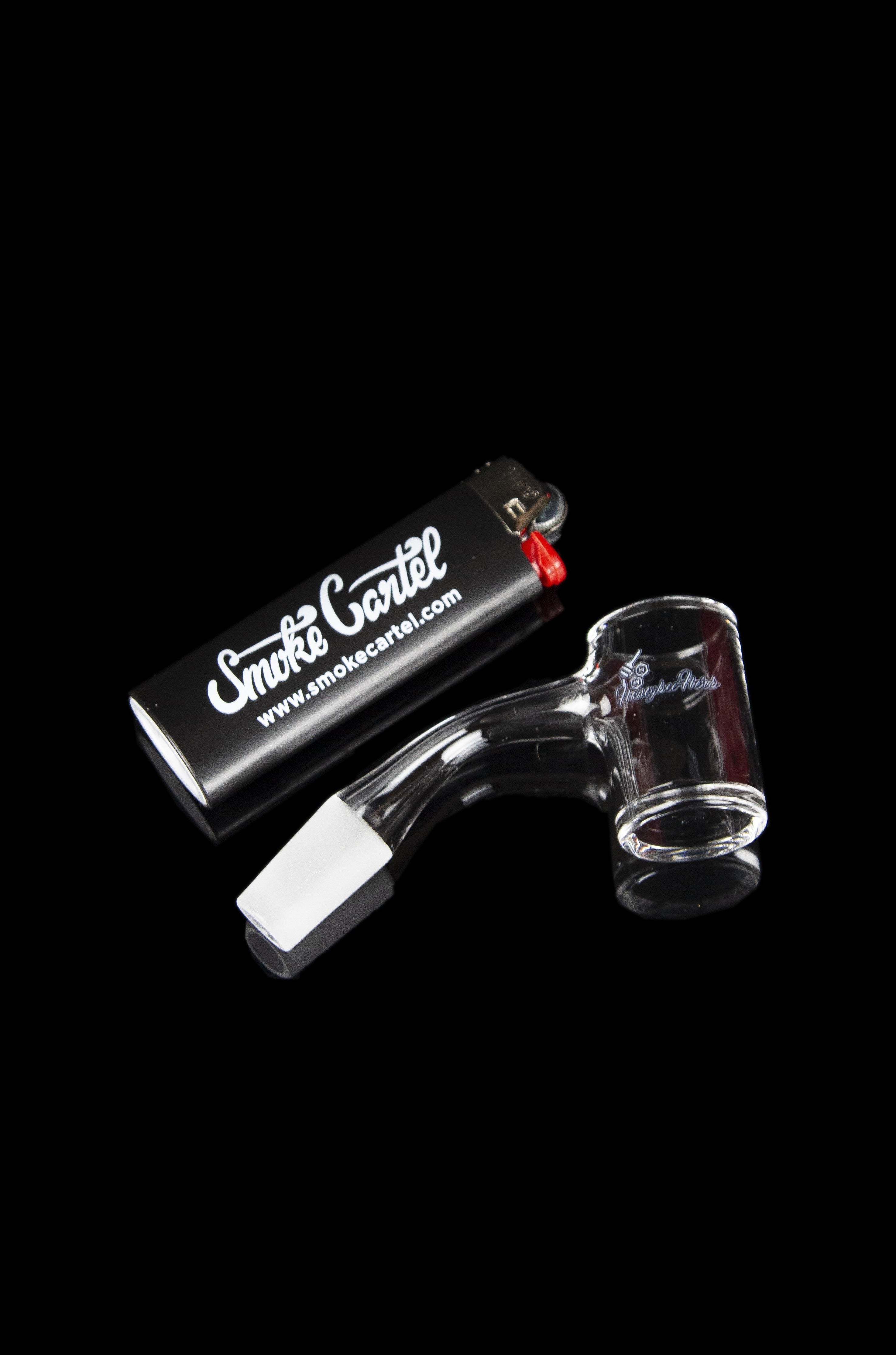 Glass oil rig with lighter and branded packaging.