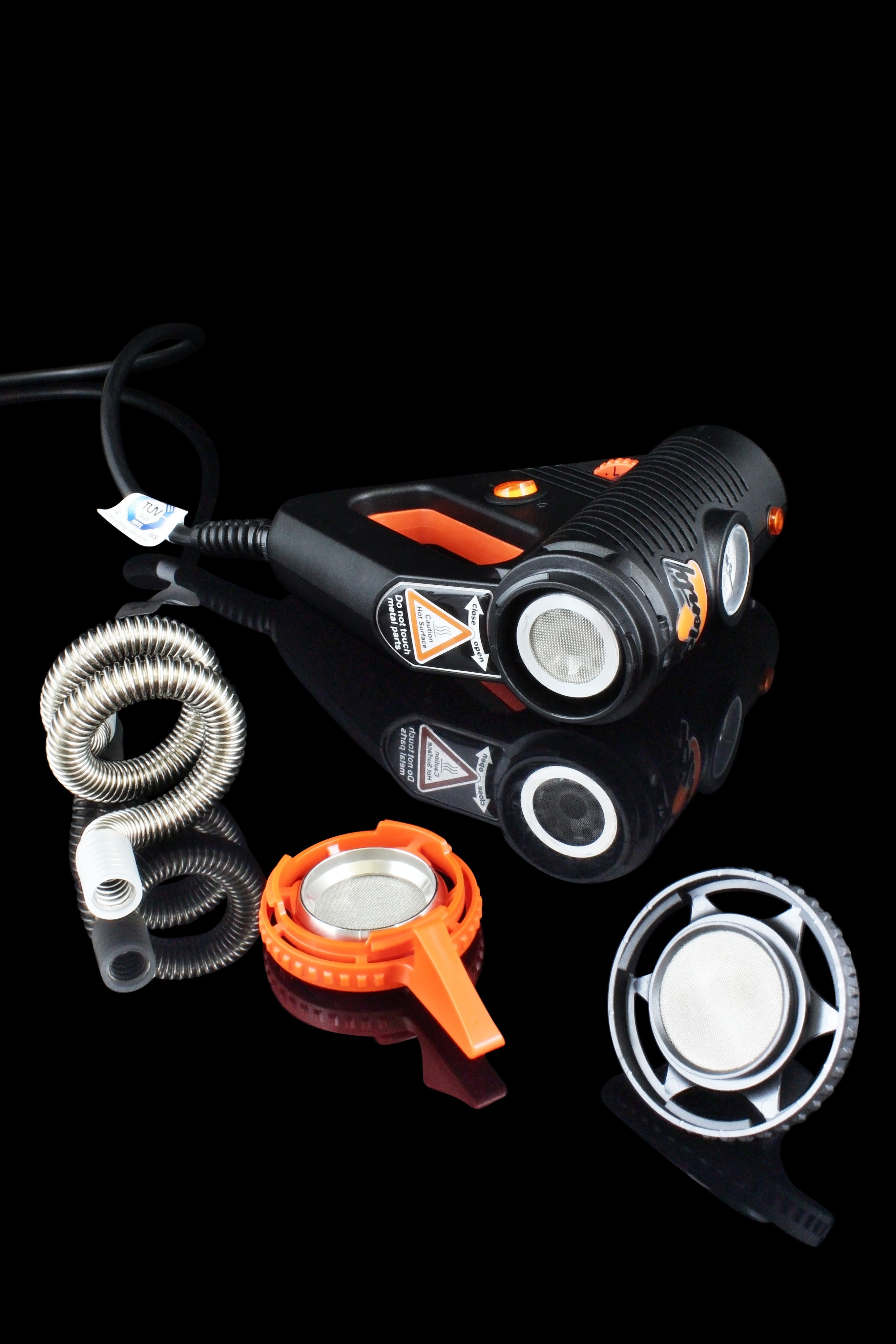 A front view of the Storz & Bickel Plenty Vaporizer with a coiled hose connected, set against a dark background.