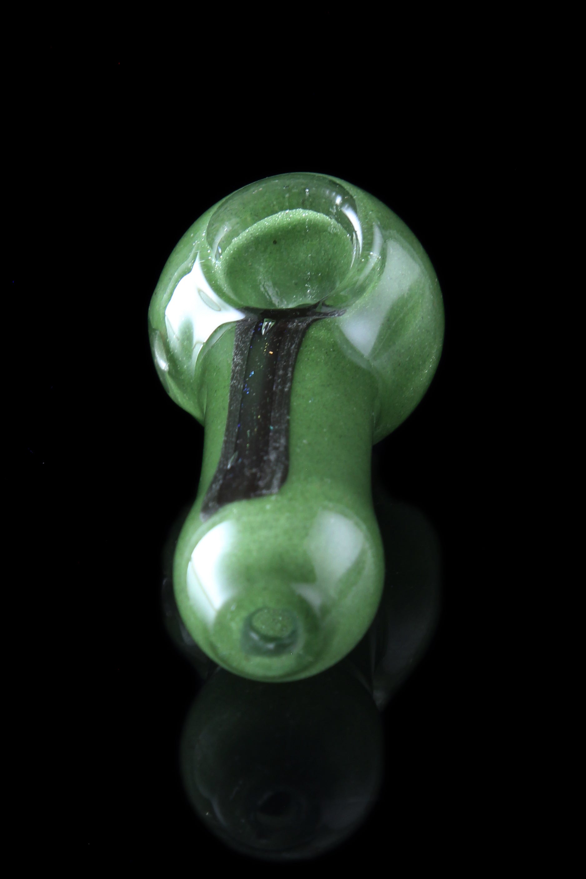 Green glass pipe with black accents, studio shot.