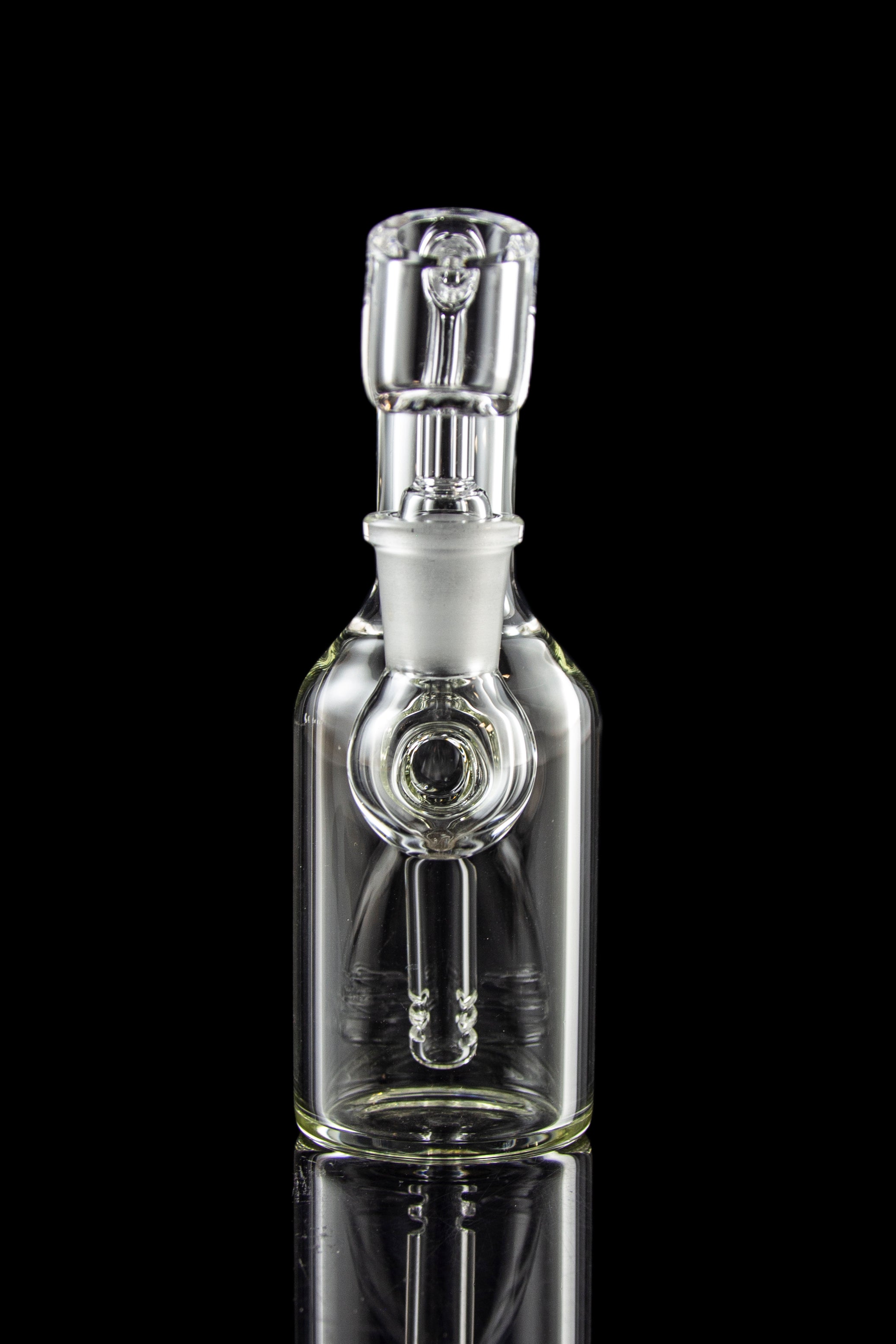 Clear glass bubbler water pipe with intricate design, reflecting on a black surface.