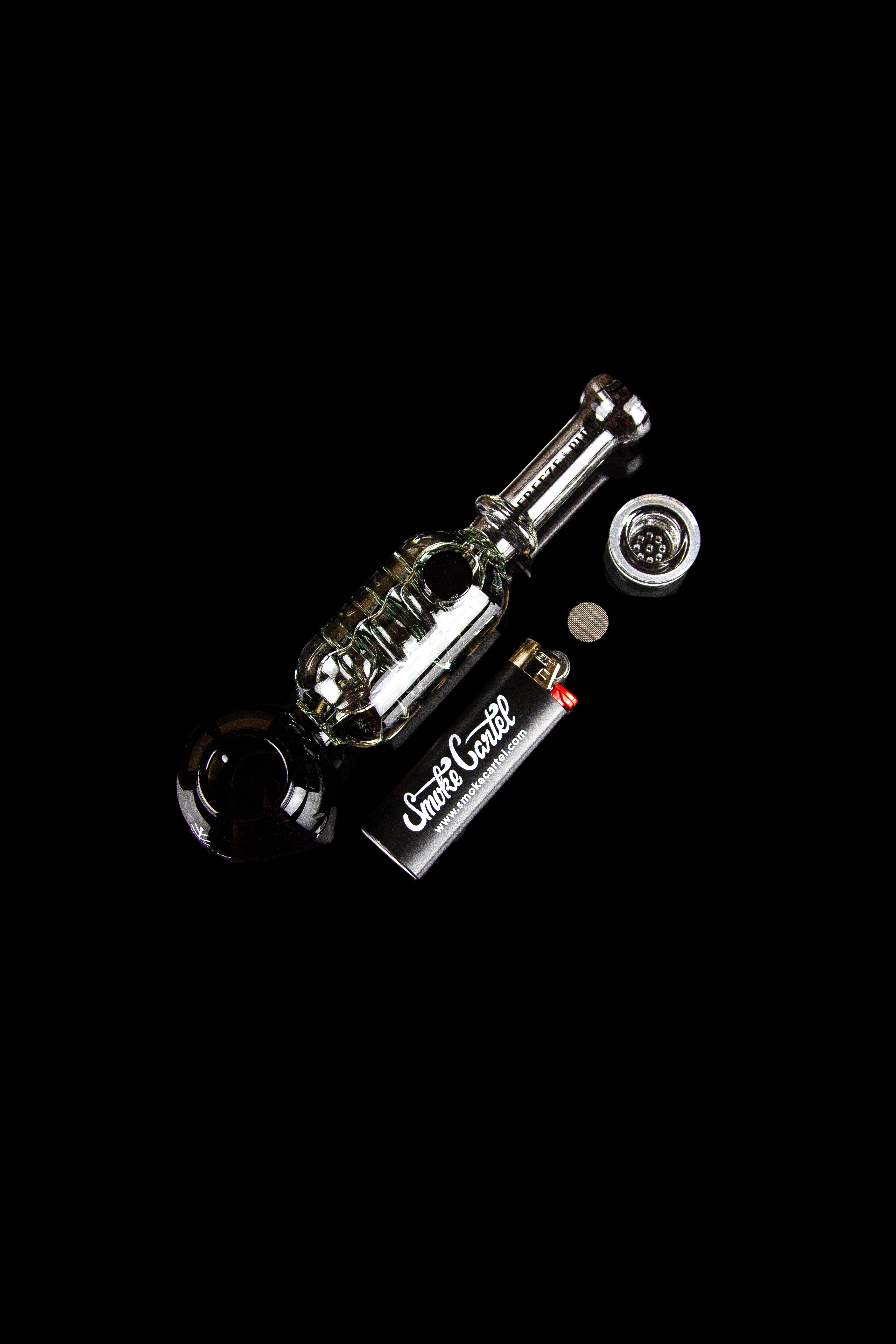 Clear glass cannabis water pipe with accessories on a black background.