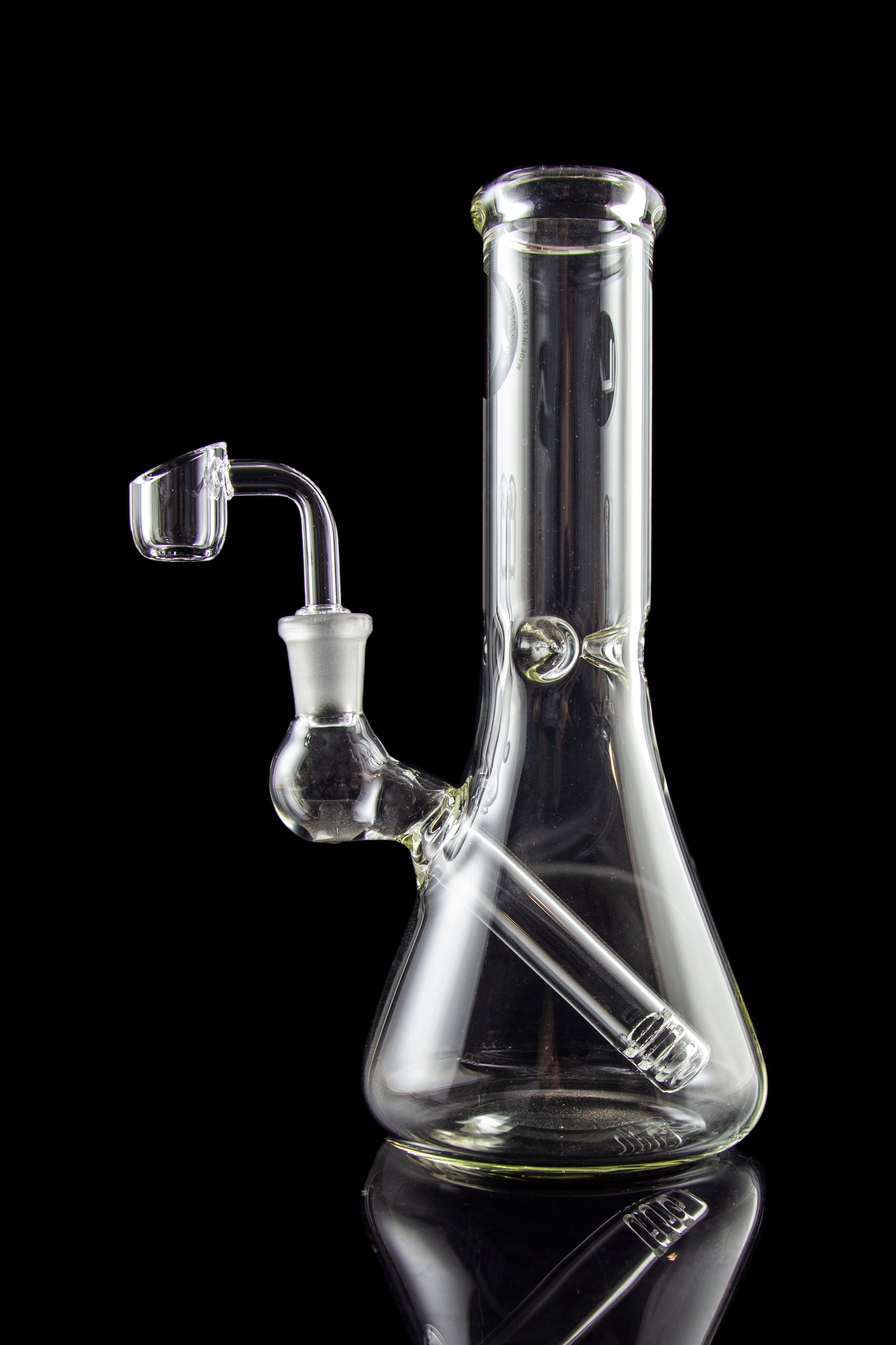 Clear glass bong with a quartz banger, isolated on black.