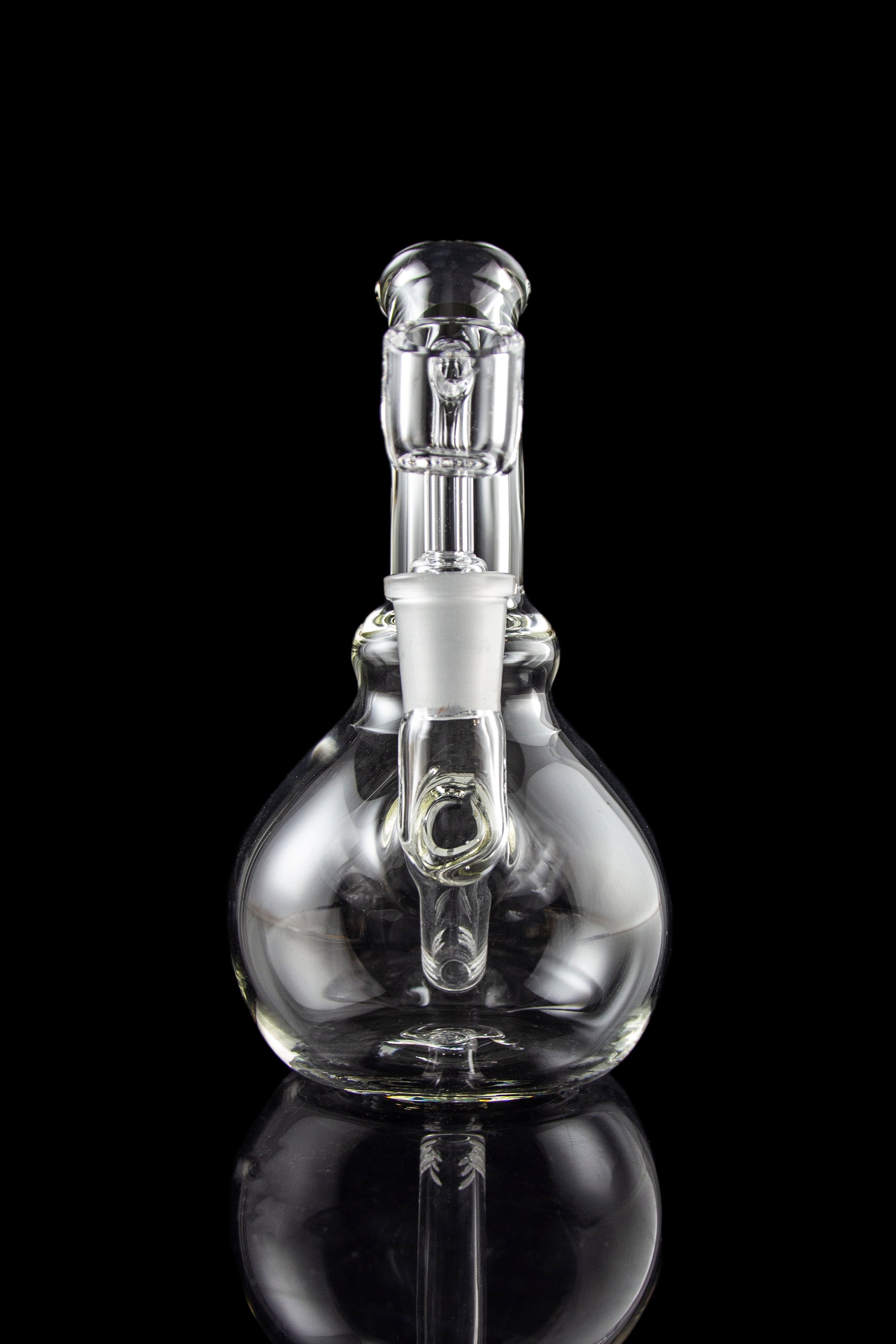 A studio shot features the LA Pipes Mini Bubble Base Concentrate Rig in clear glass, reflected on a dark surface.