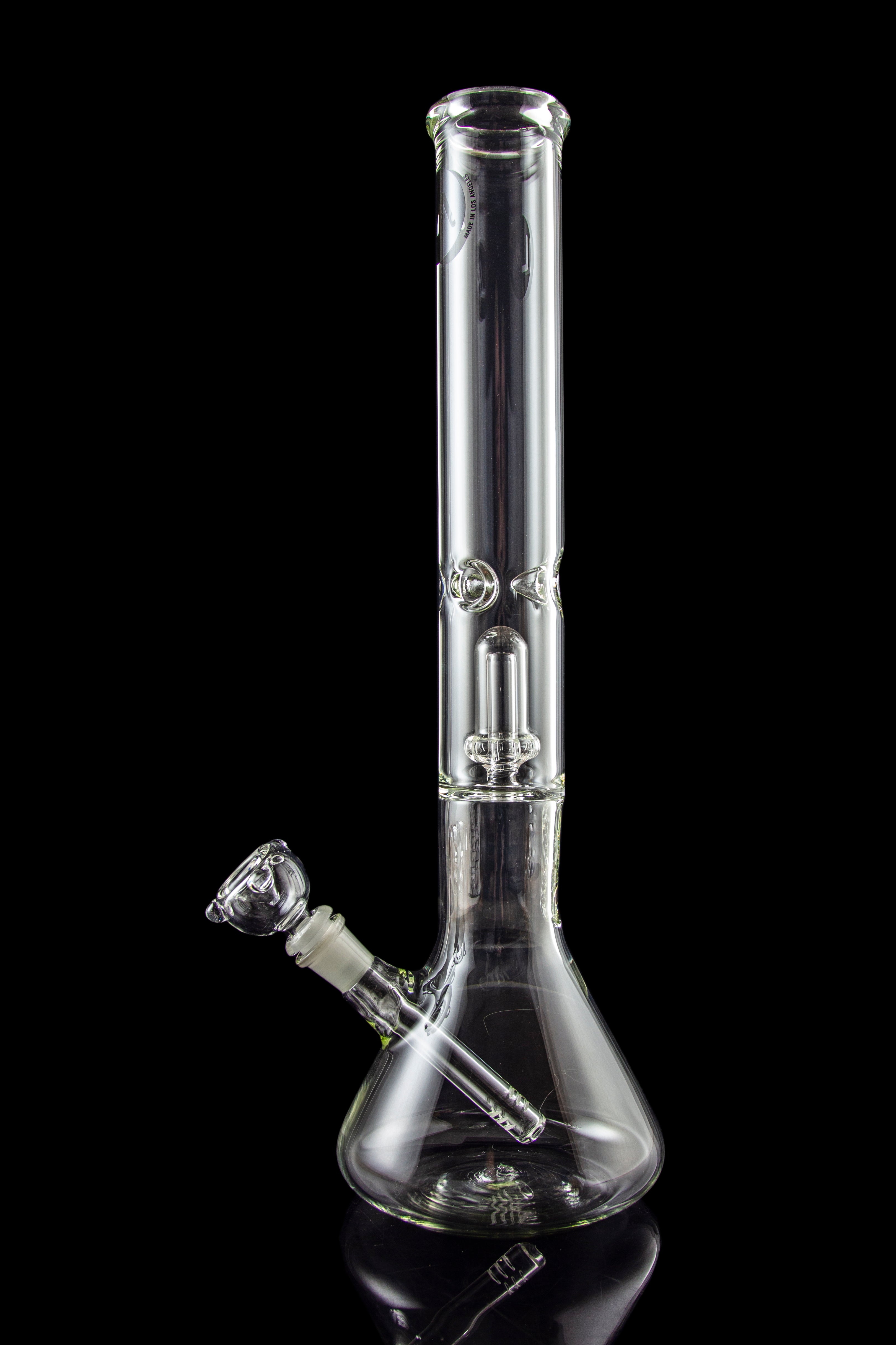Clear glass bong with intricate percolator, isolated on black.