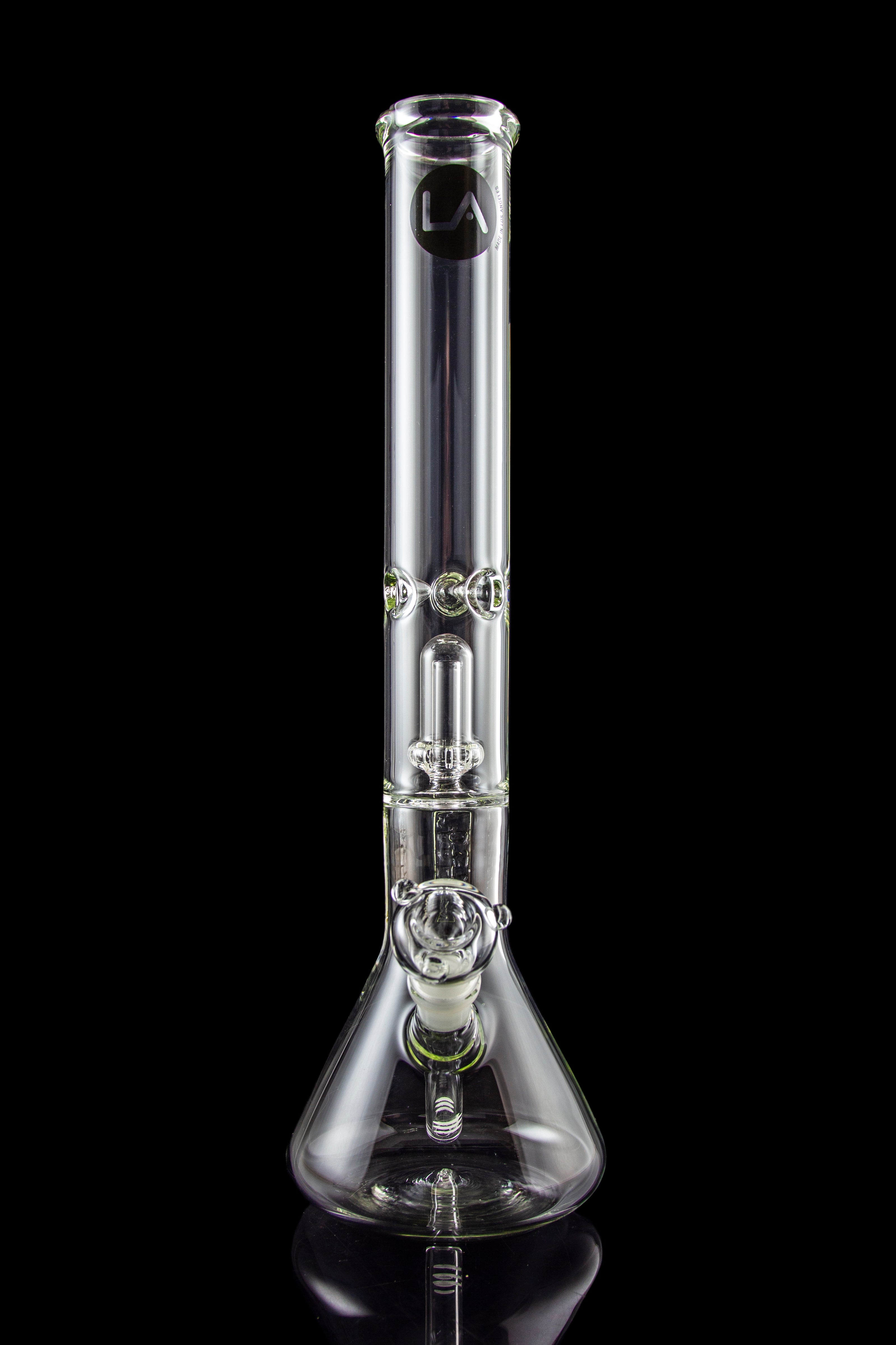 Clear glass bong with ice catcher and flared base, studio shot on a black reflective surface.