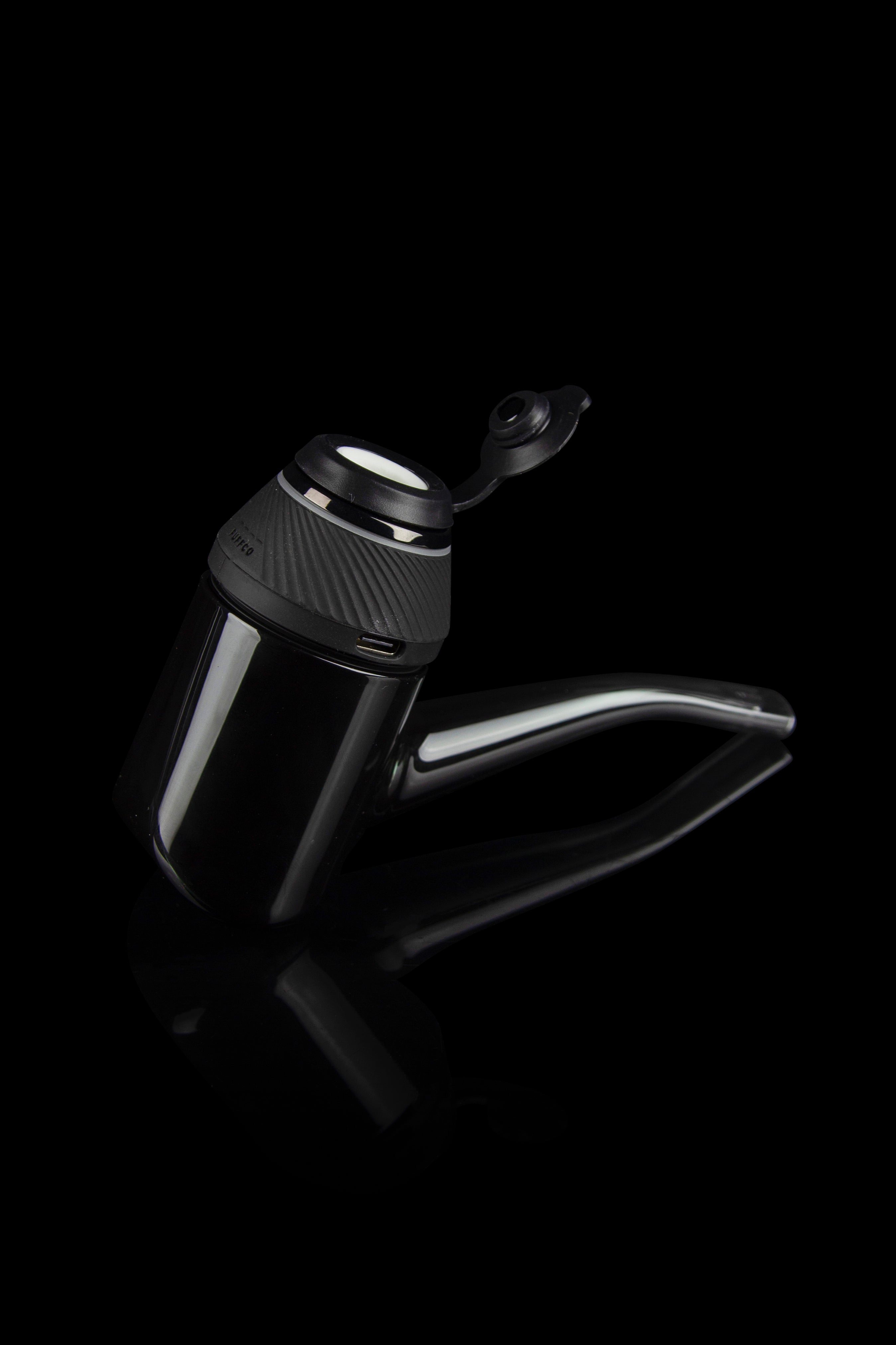 Sleek, black cannabis oil vape pen with a glass mouthpiece, isolated on a dark background.