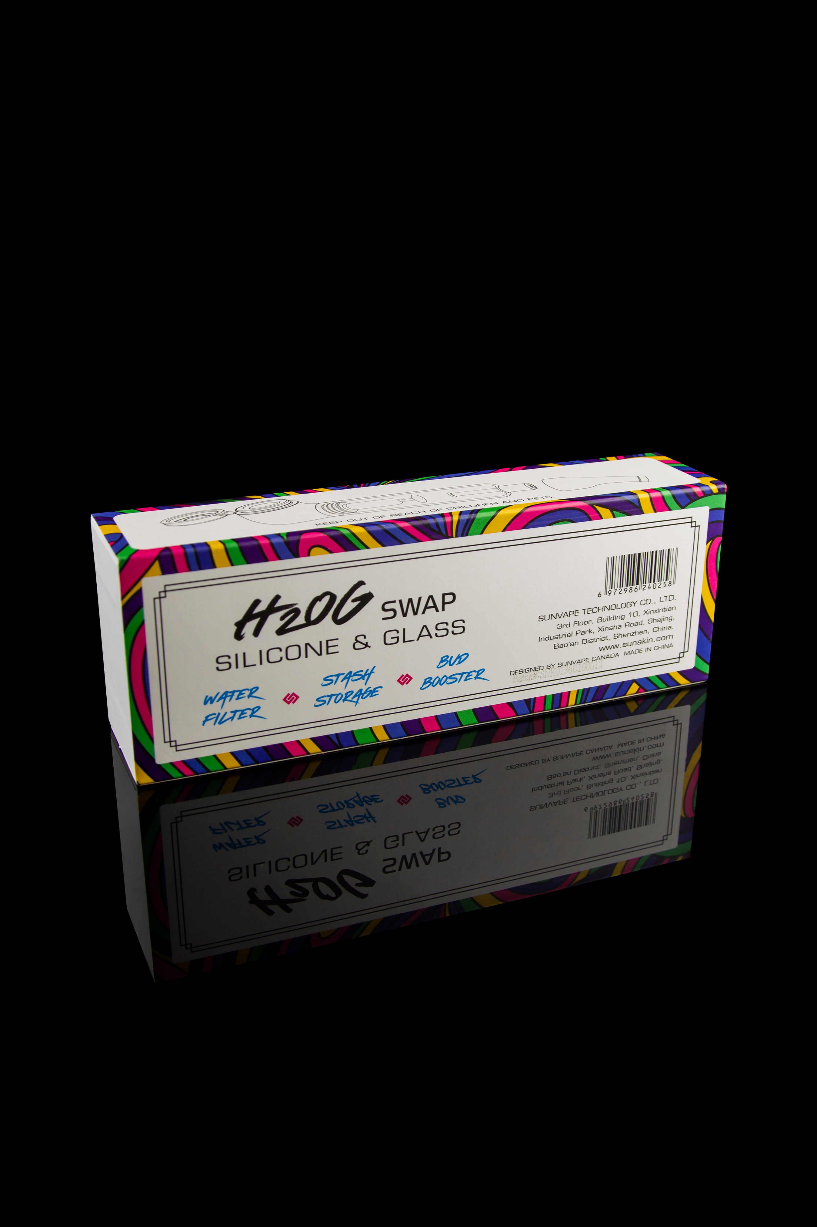 A rectangular box for cannabis accessories with colorful geometric patterns, labeled "H2OG Swap Silicone & Glass" and listing features like "water filter," "stash storage," and "bud booster," reflected on a glossy black surface.