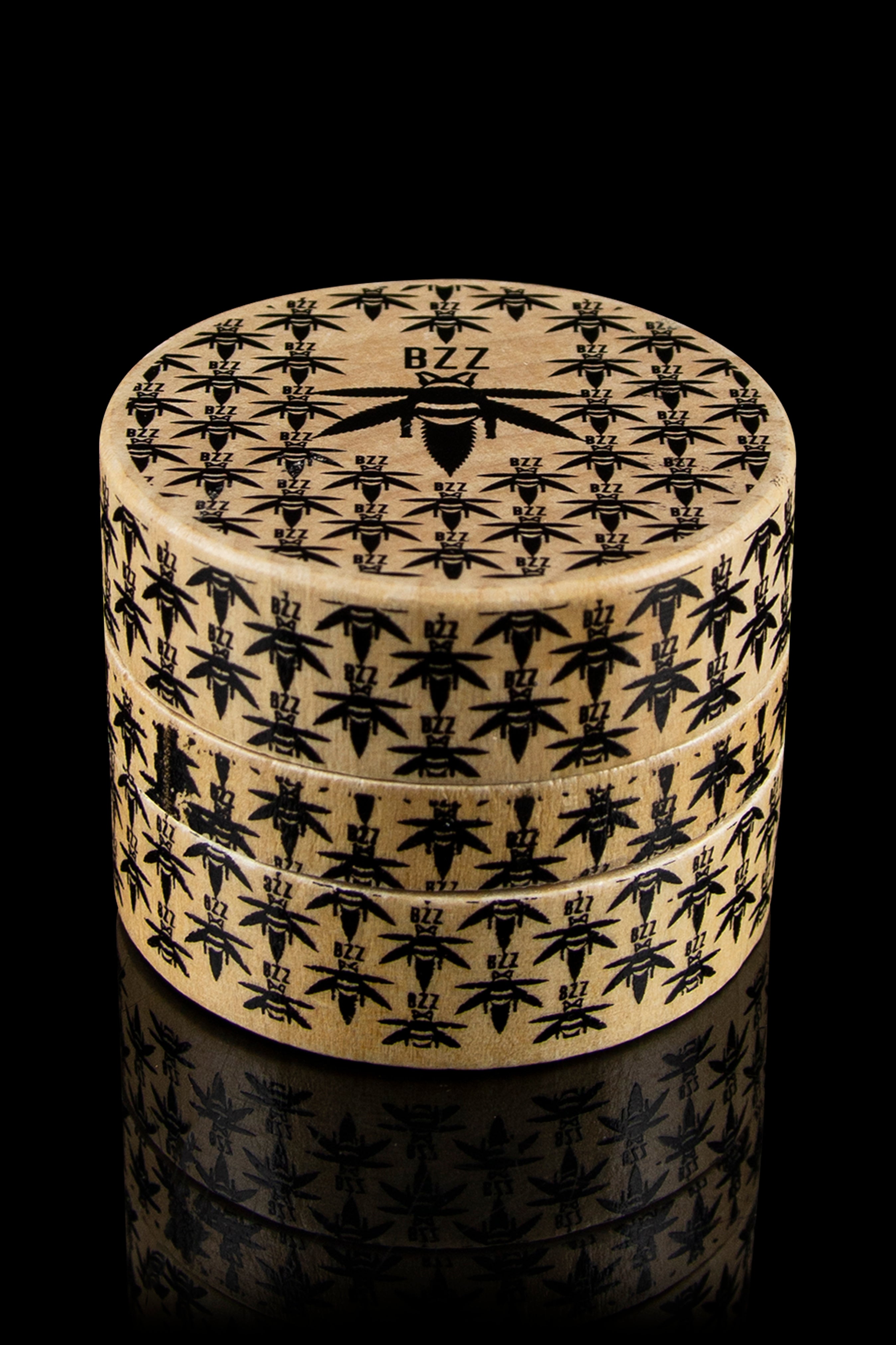A stack of cylindrical containers with an all-over pattern of cannabis leaves, branded with "BZZ" on the top container.