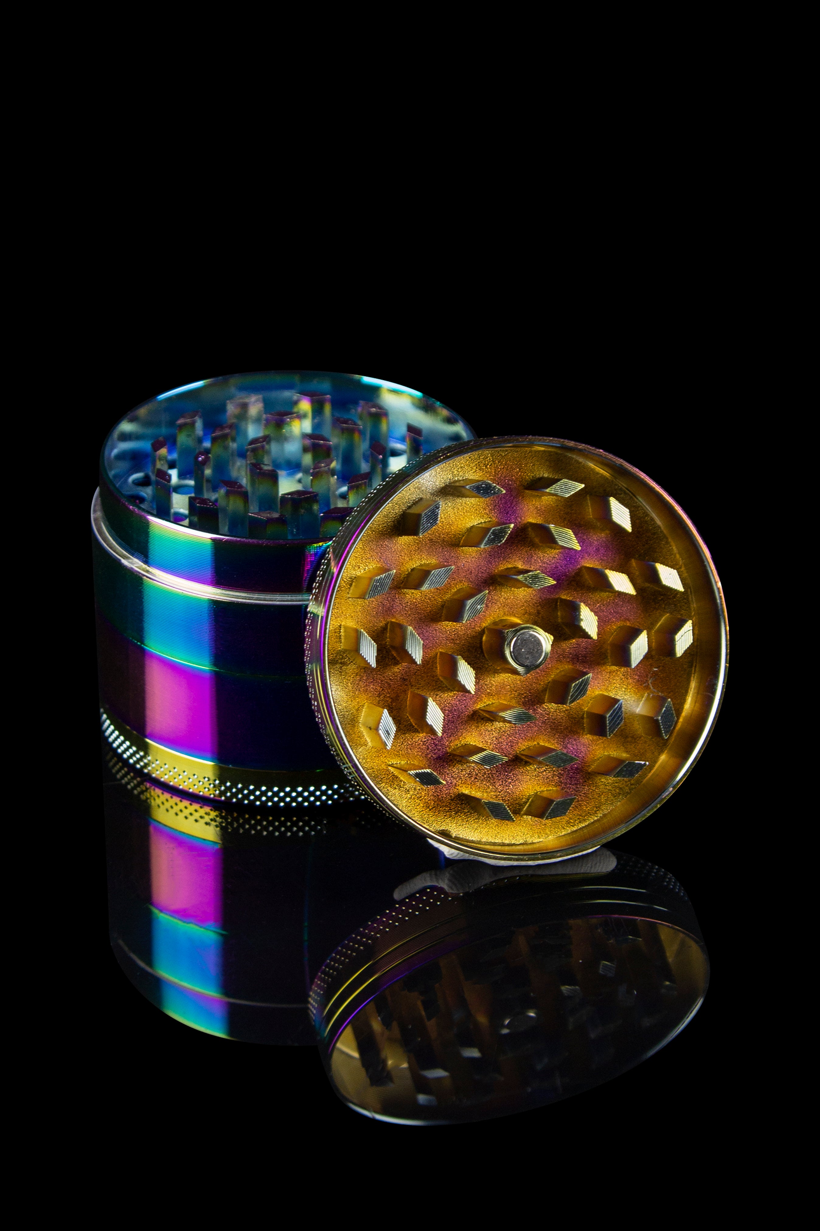 Iridescent cannabis grinder with open chambers, displayed against a black background.