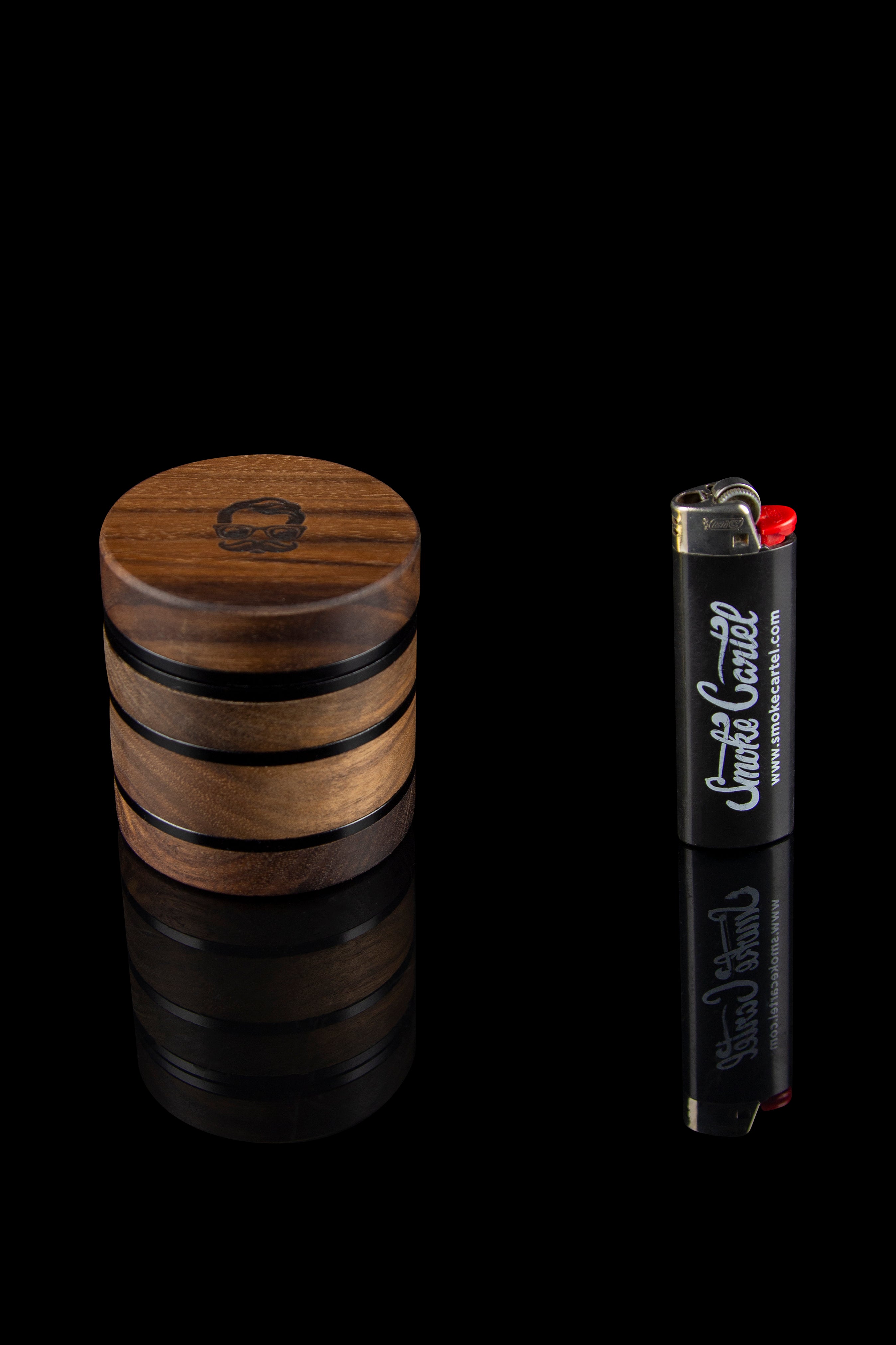 Wooden grinder and lighter with cannabis-related branding against a black background.