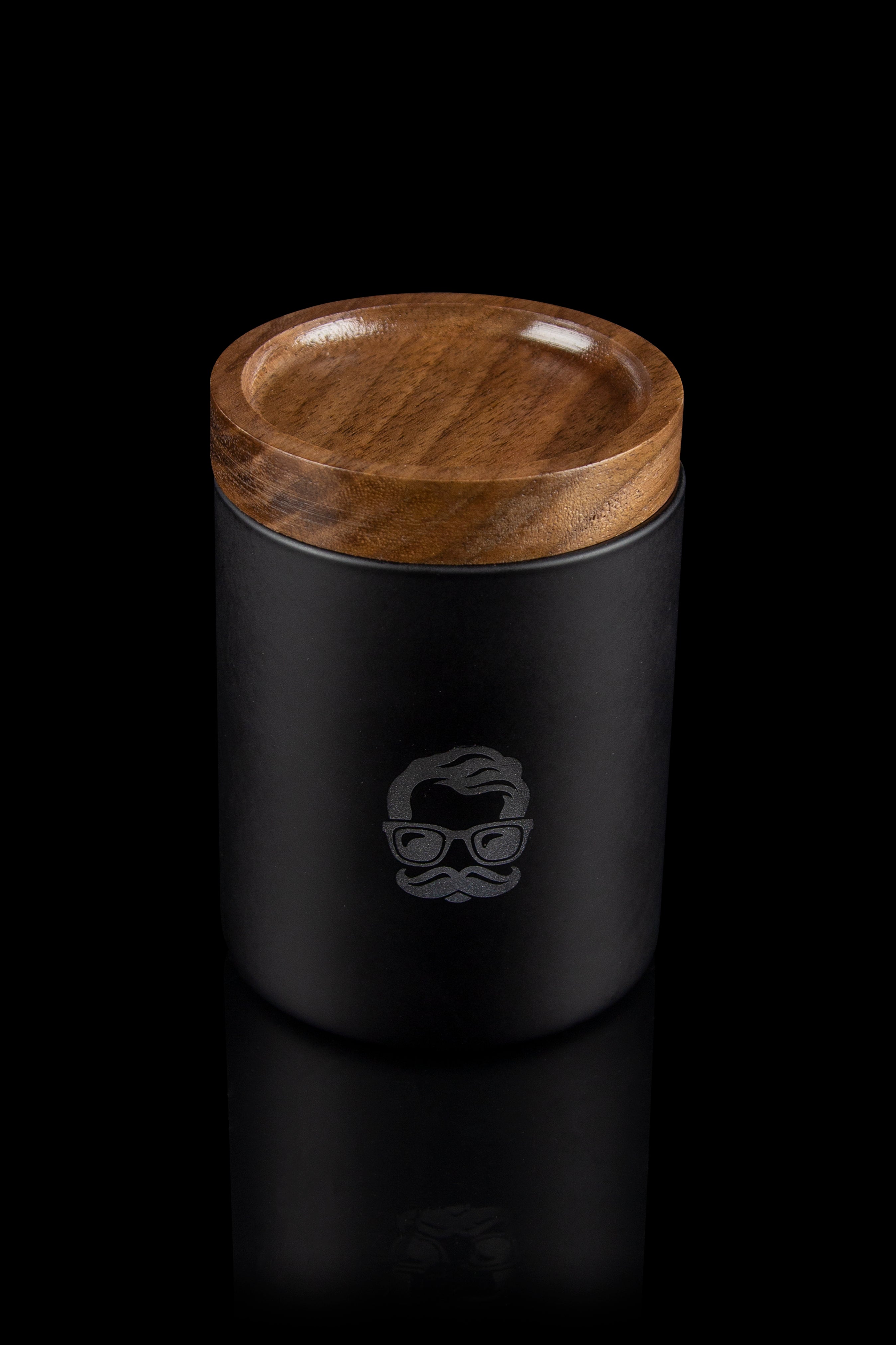 Black cannabis storage container with a wooden lid and a stylized mustache emblem.