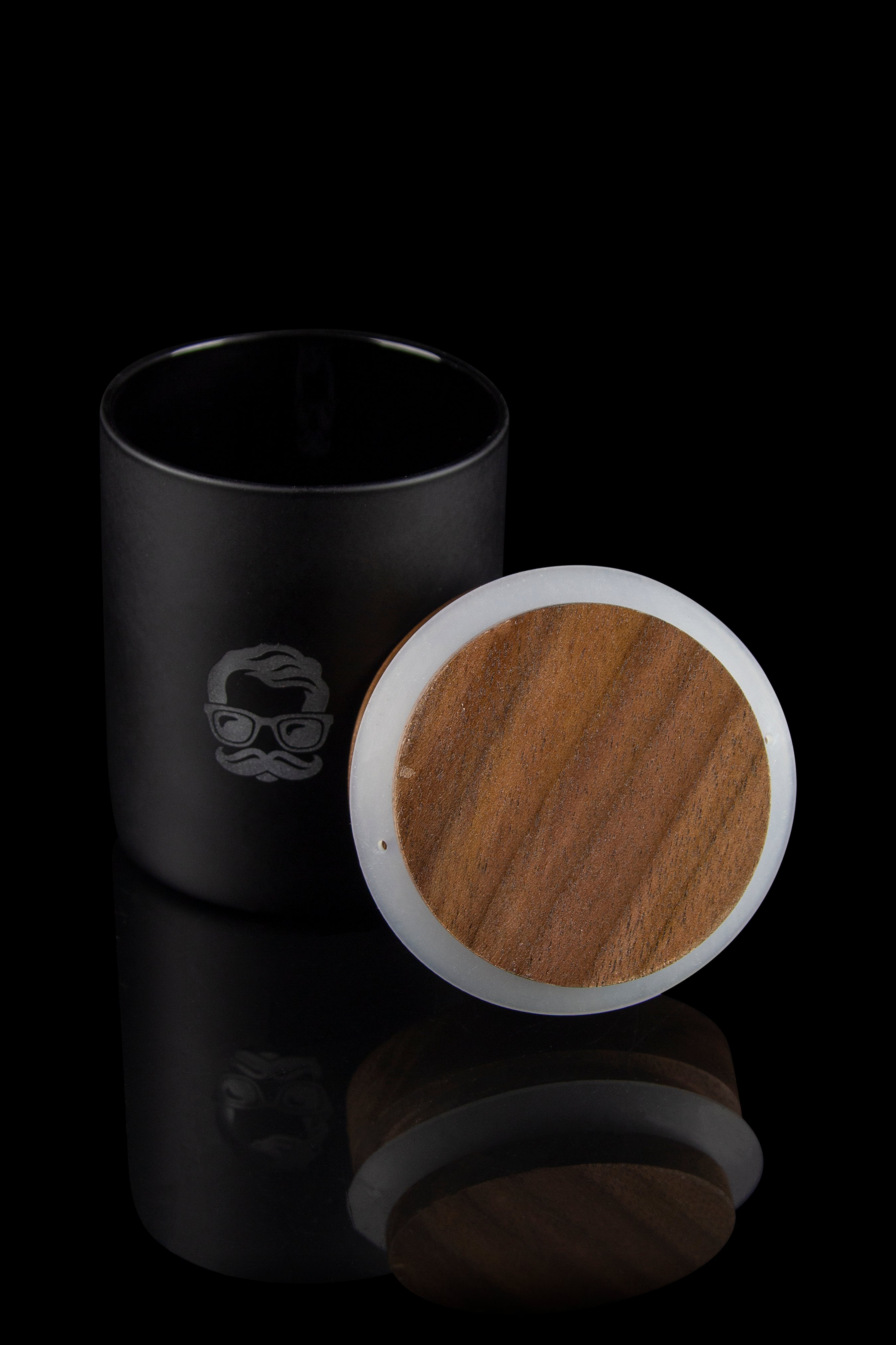 Sleek black storage container with a wooden lid, designed for cannabis or accessories, displayed on a reflective surface.