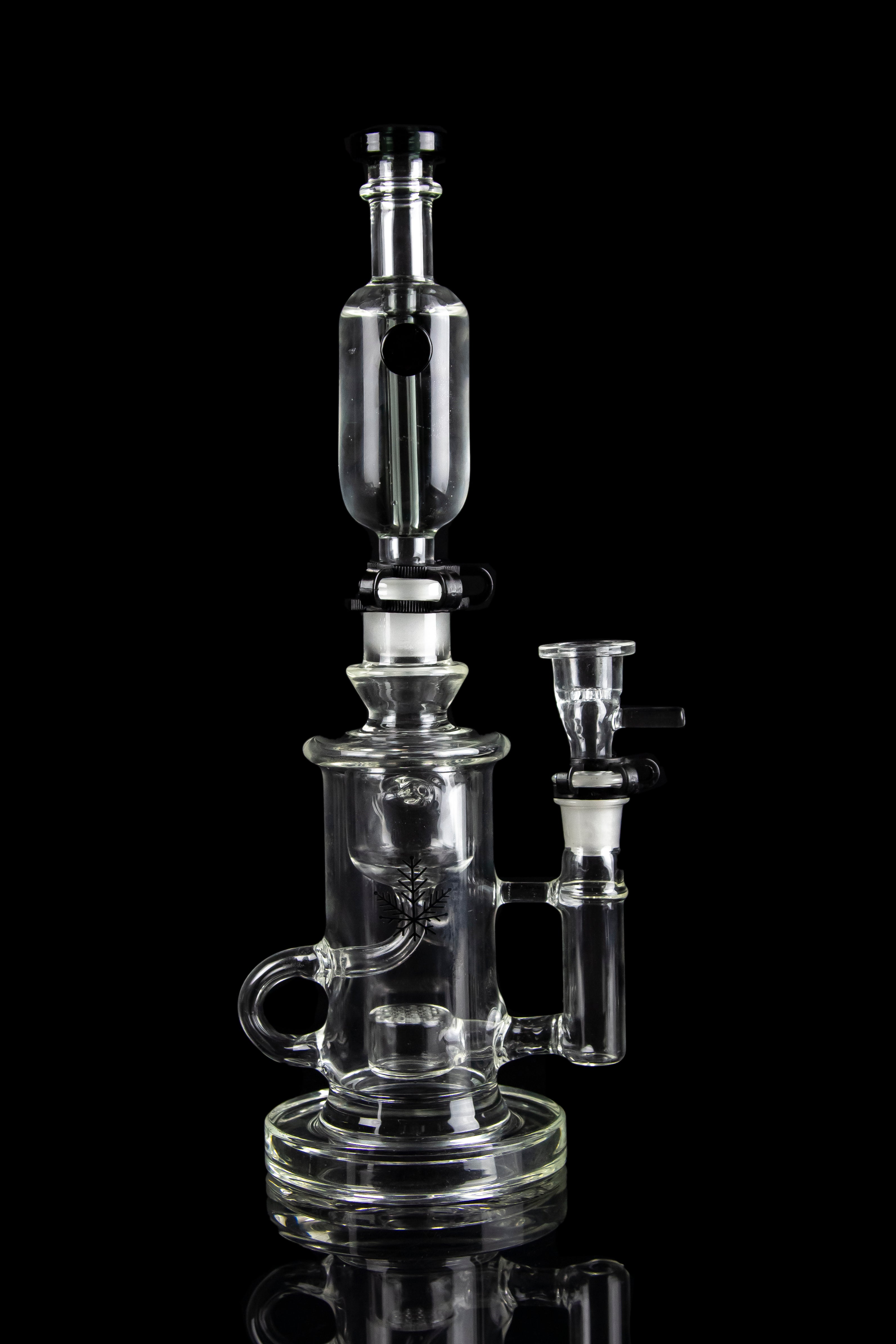 Clear glass water pipe (rig) with intricate branching percolators, against a black background.