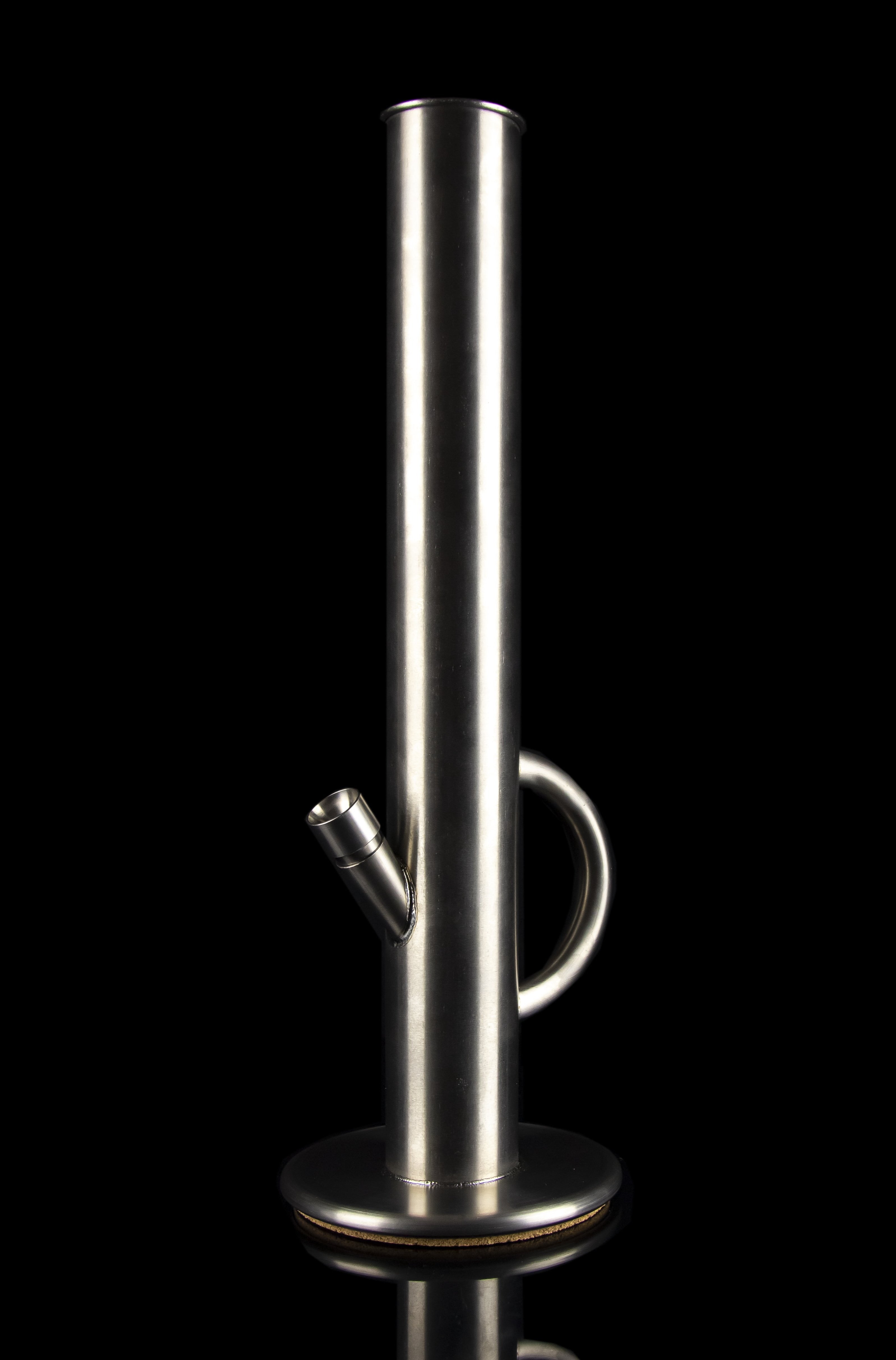 Polished metal cannabis bong against a black background.