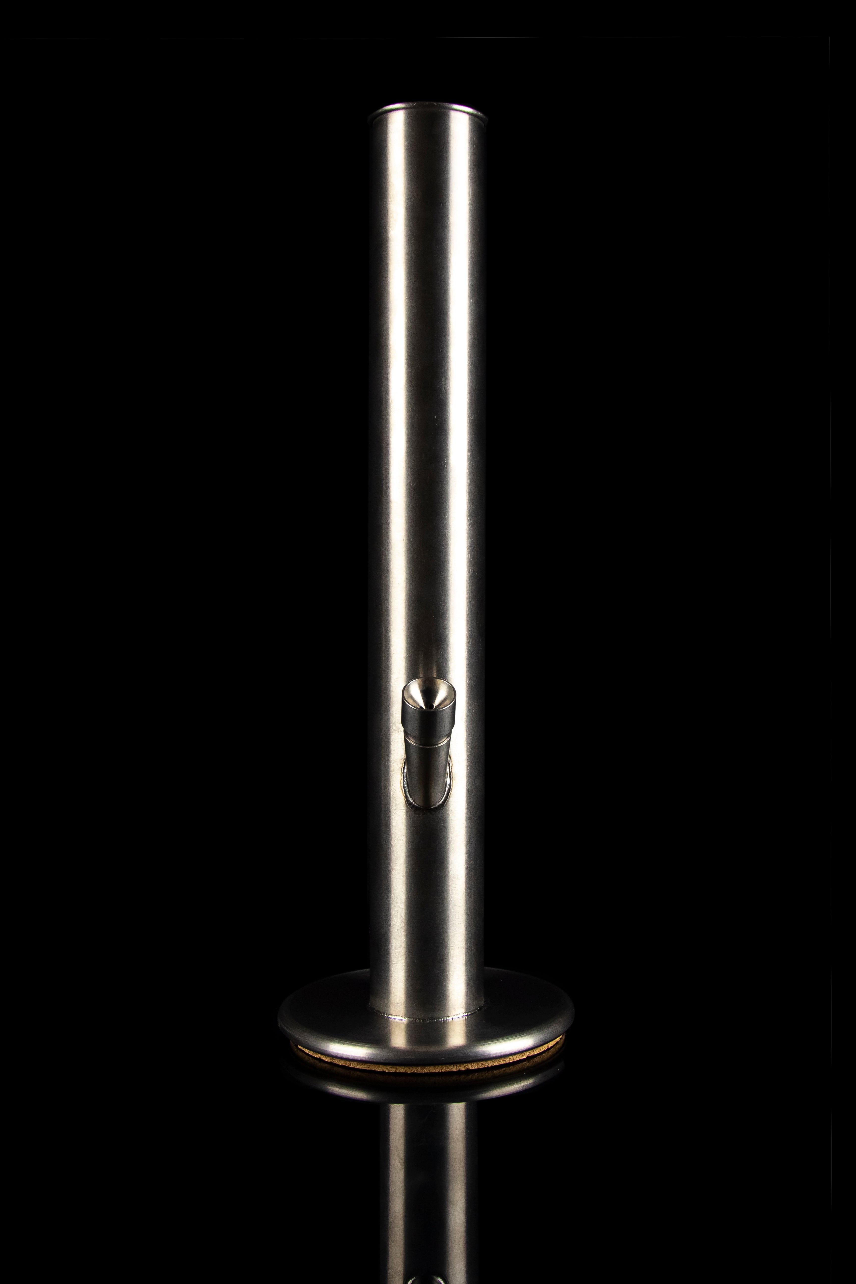 Sleek, silver cannabis water pipe with a glass mouthpiece, isolated on black.