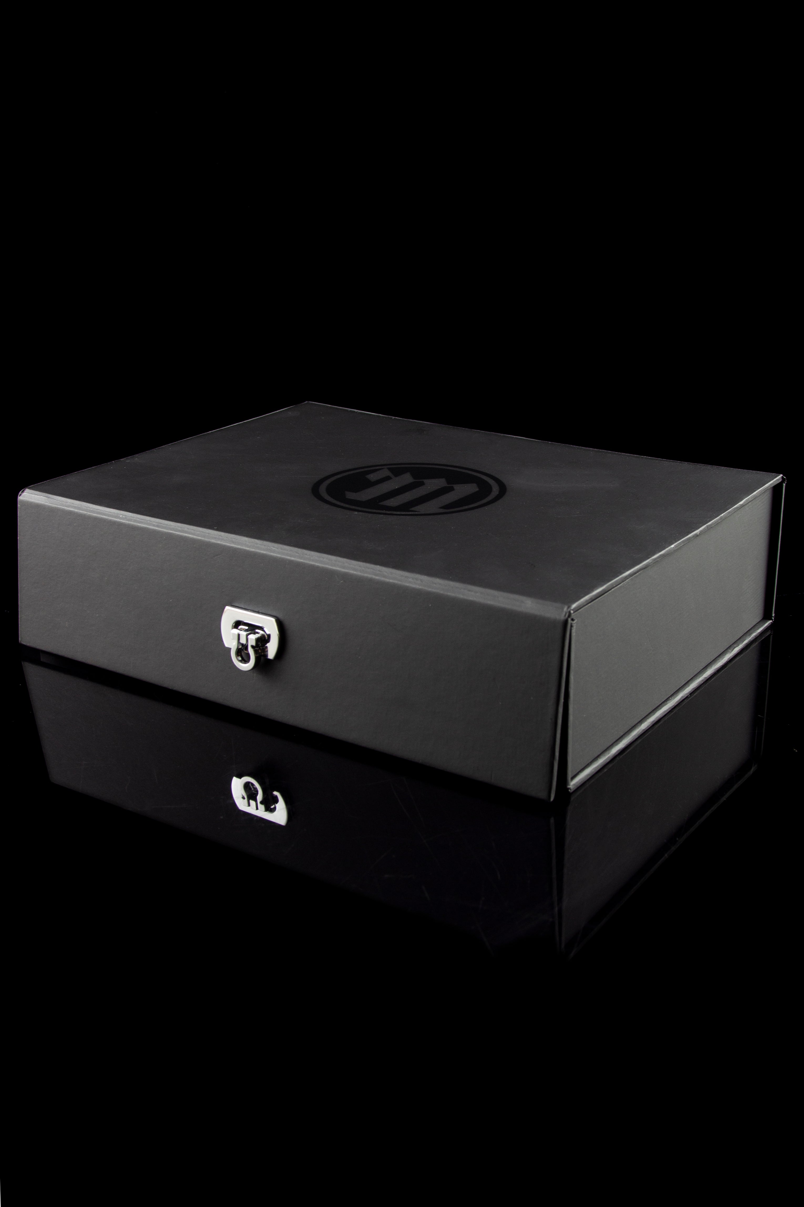 Black locked cannabis storage box with reflective surface.