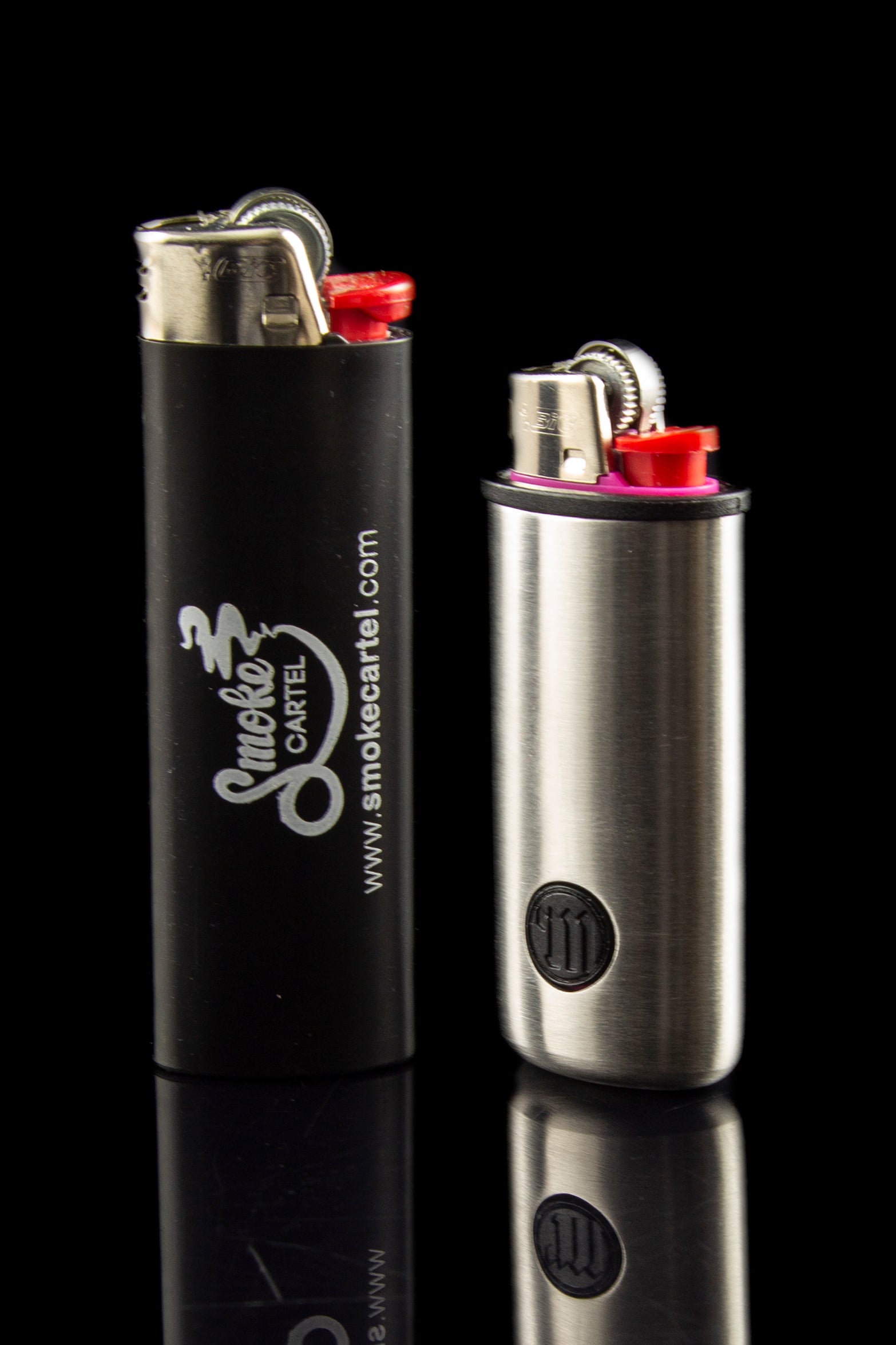 Two butane lighters with branding for Smoke Cartel, displayed on a reflective black surface.