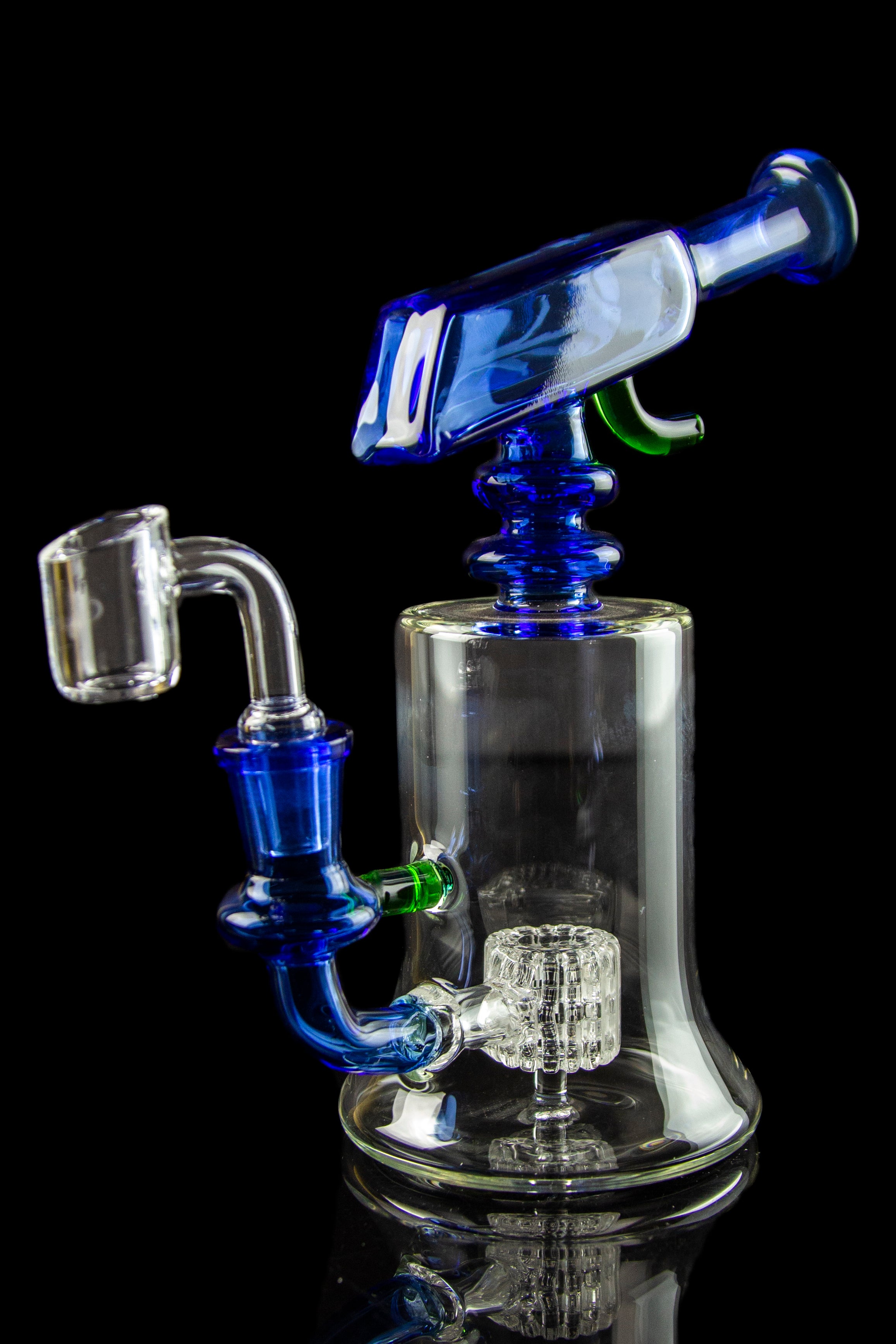Blue glass dab rig with quartz banger and intricate percolator, isolated on black.