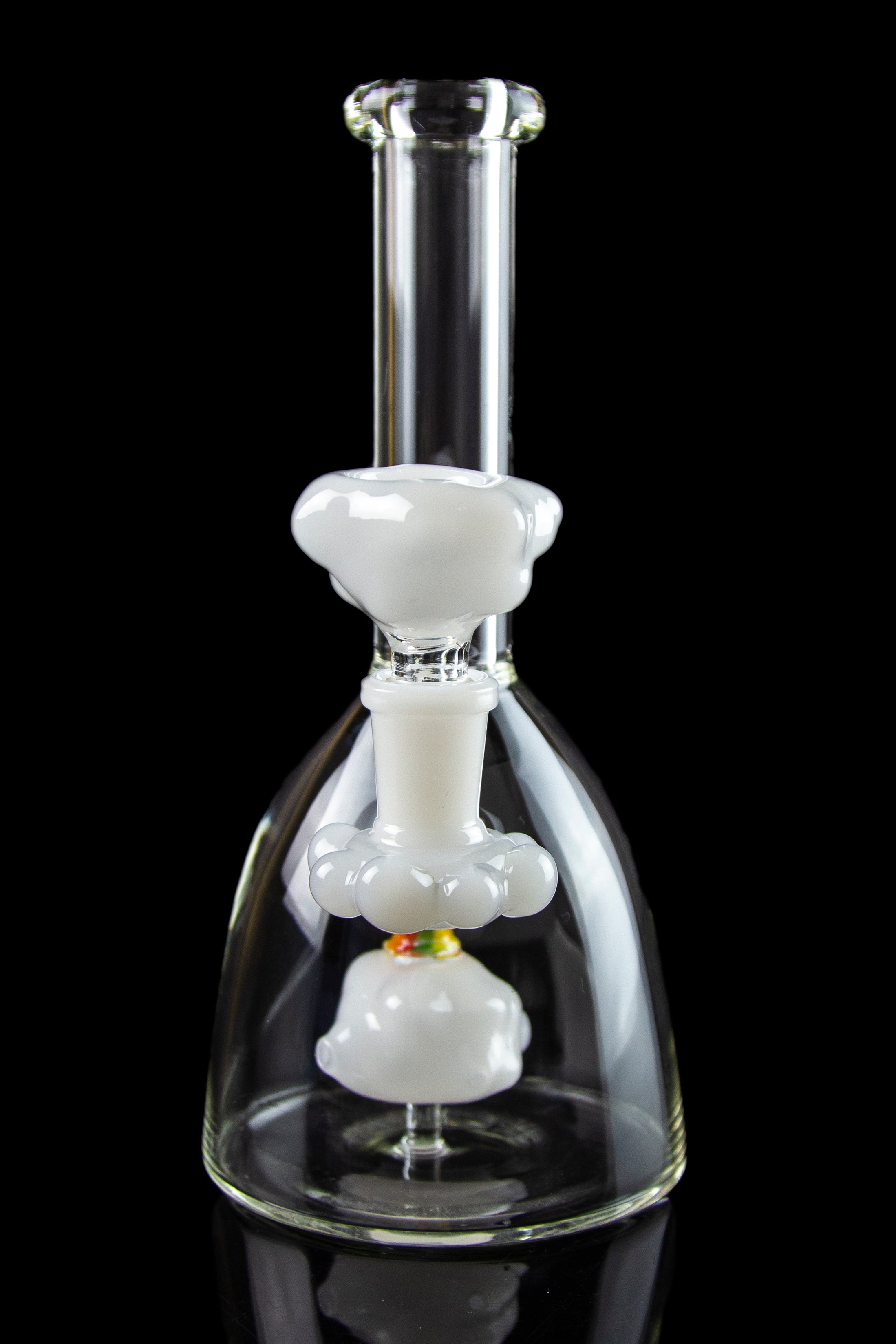 Glass bubbler water pipe with white percolator chambers against a black background.