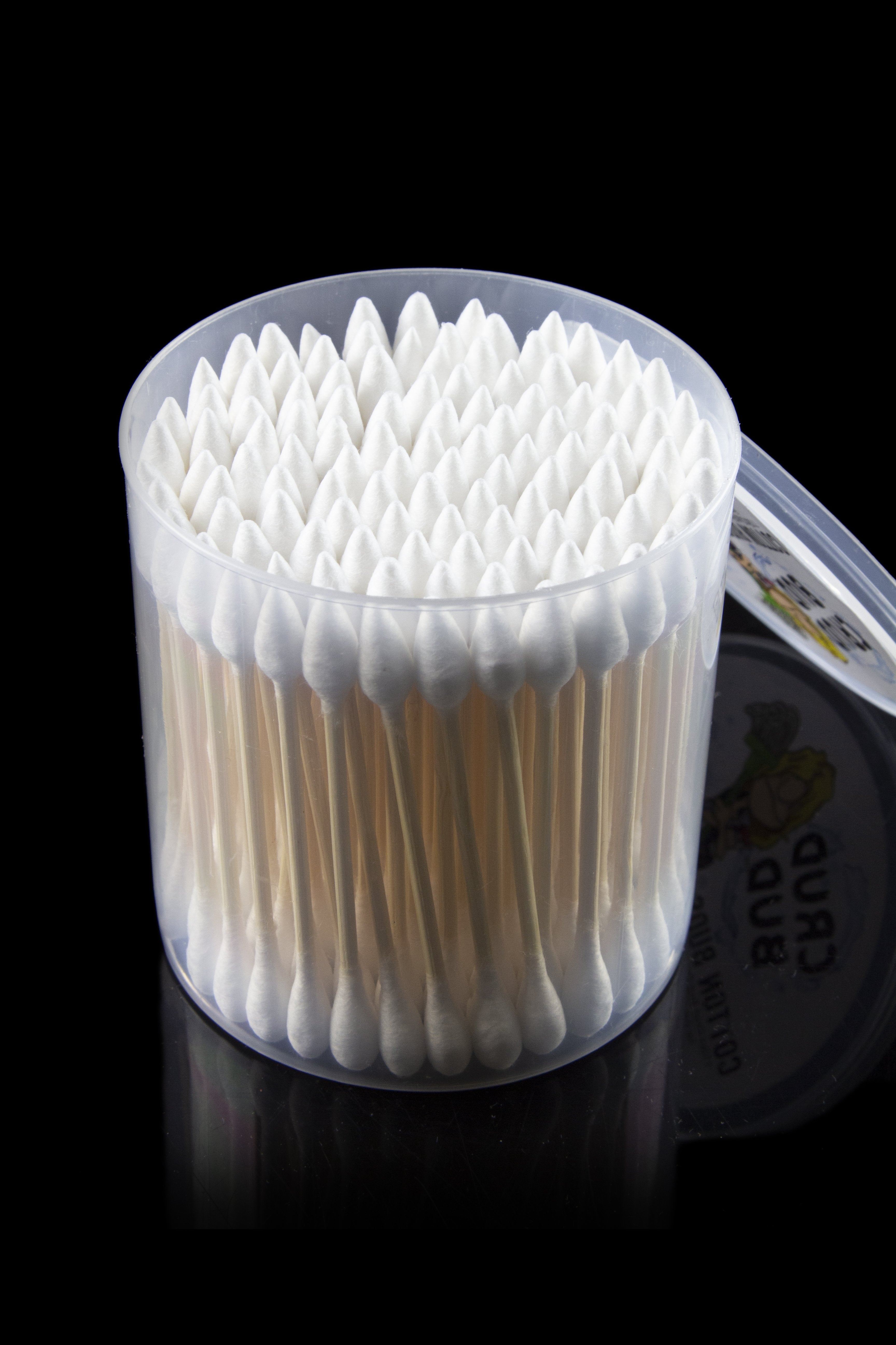 Close-up top-front view of a round tub of Crud Bud Cotton Swabs Tips 5.00% Off Auto renew showing tightly packed white swab tips against a black background