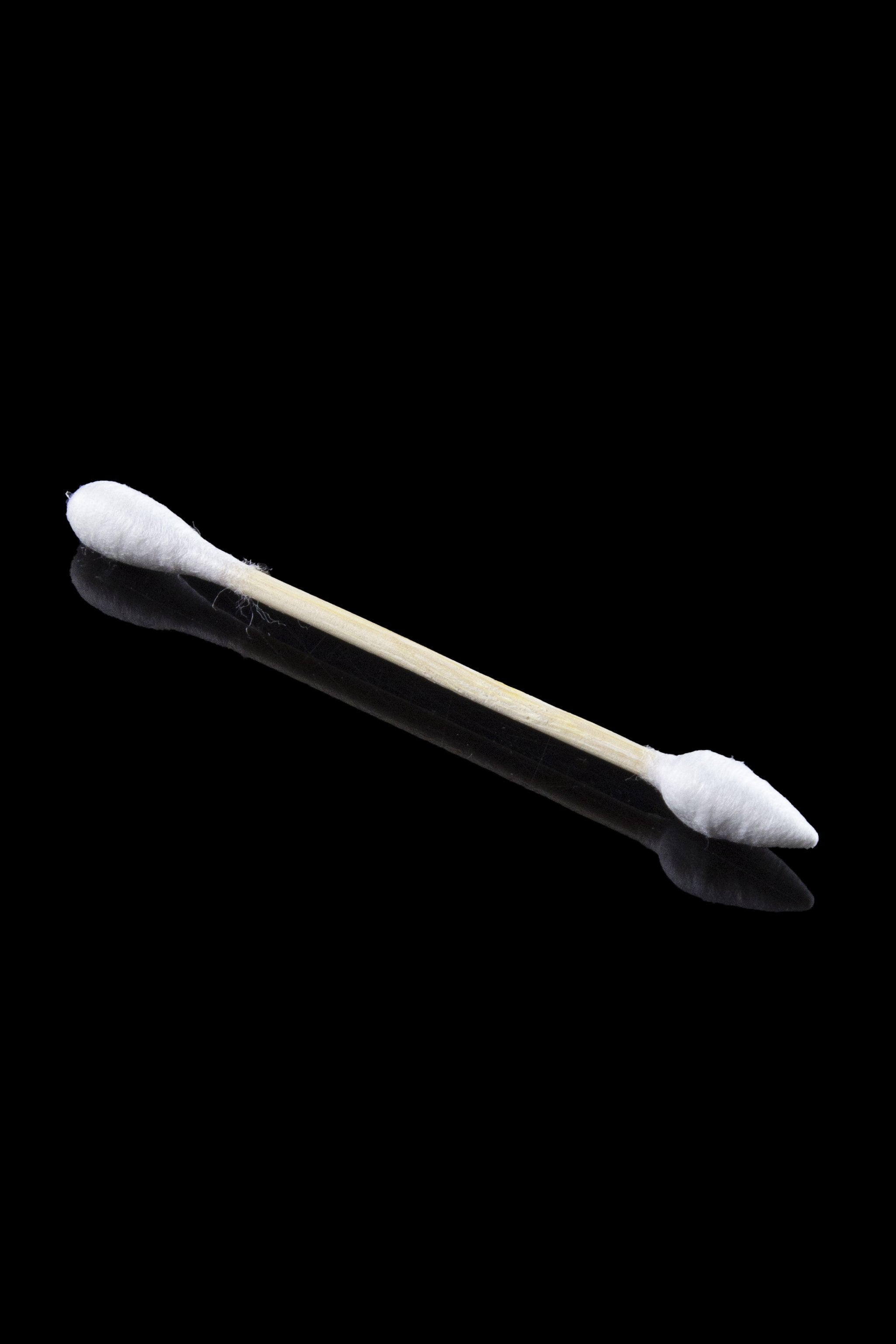 Diagonal close-up of a single wooden cotton swab with white tips against a black background, Crud Bud Cotton Swabs Tips 5.00% Off Auto renew