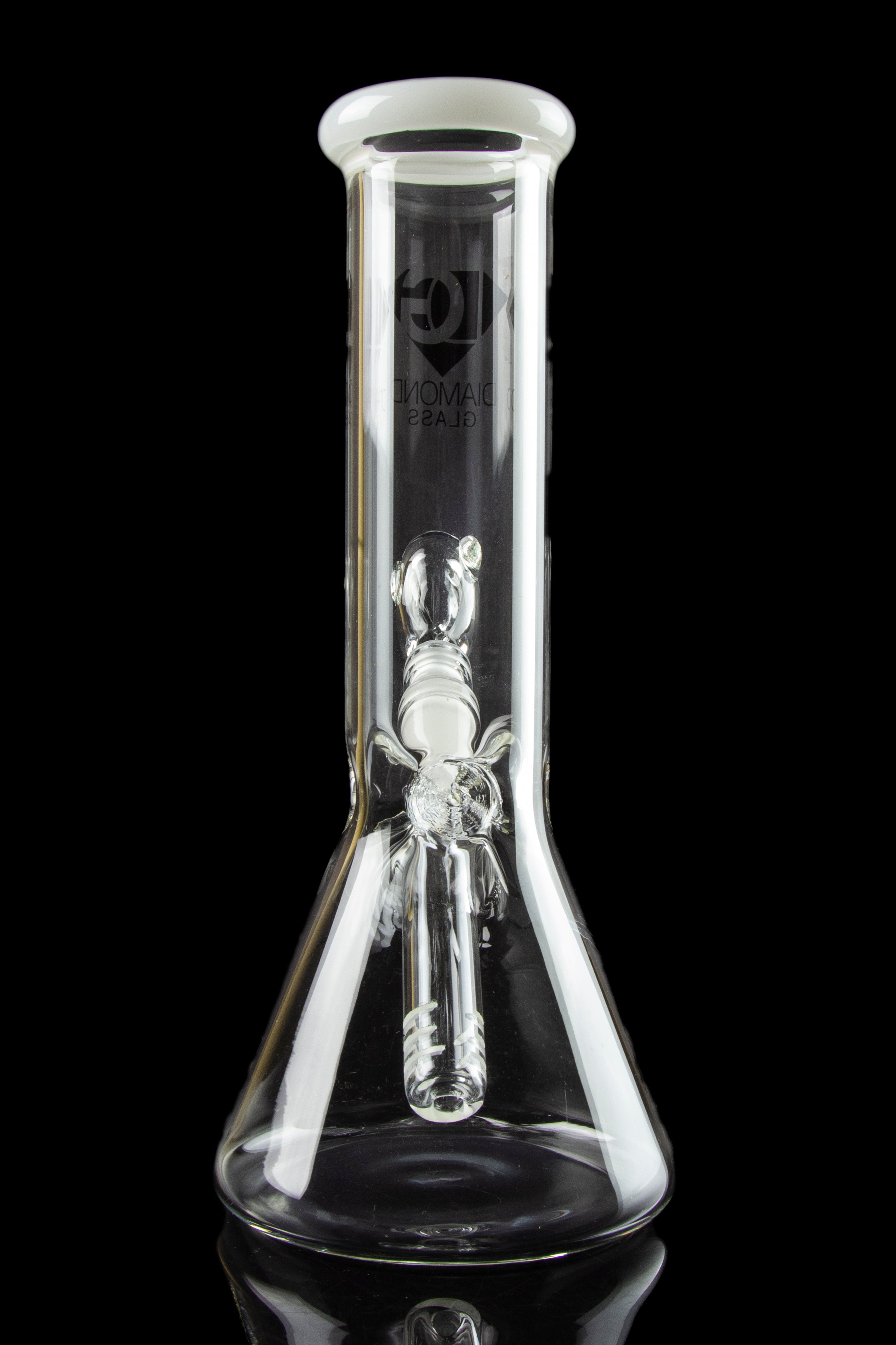 Clear glass bong with intricate sculpted artwork inside, reflecting on a glossy black surface.