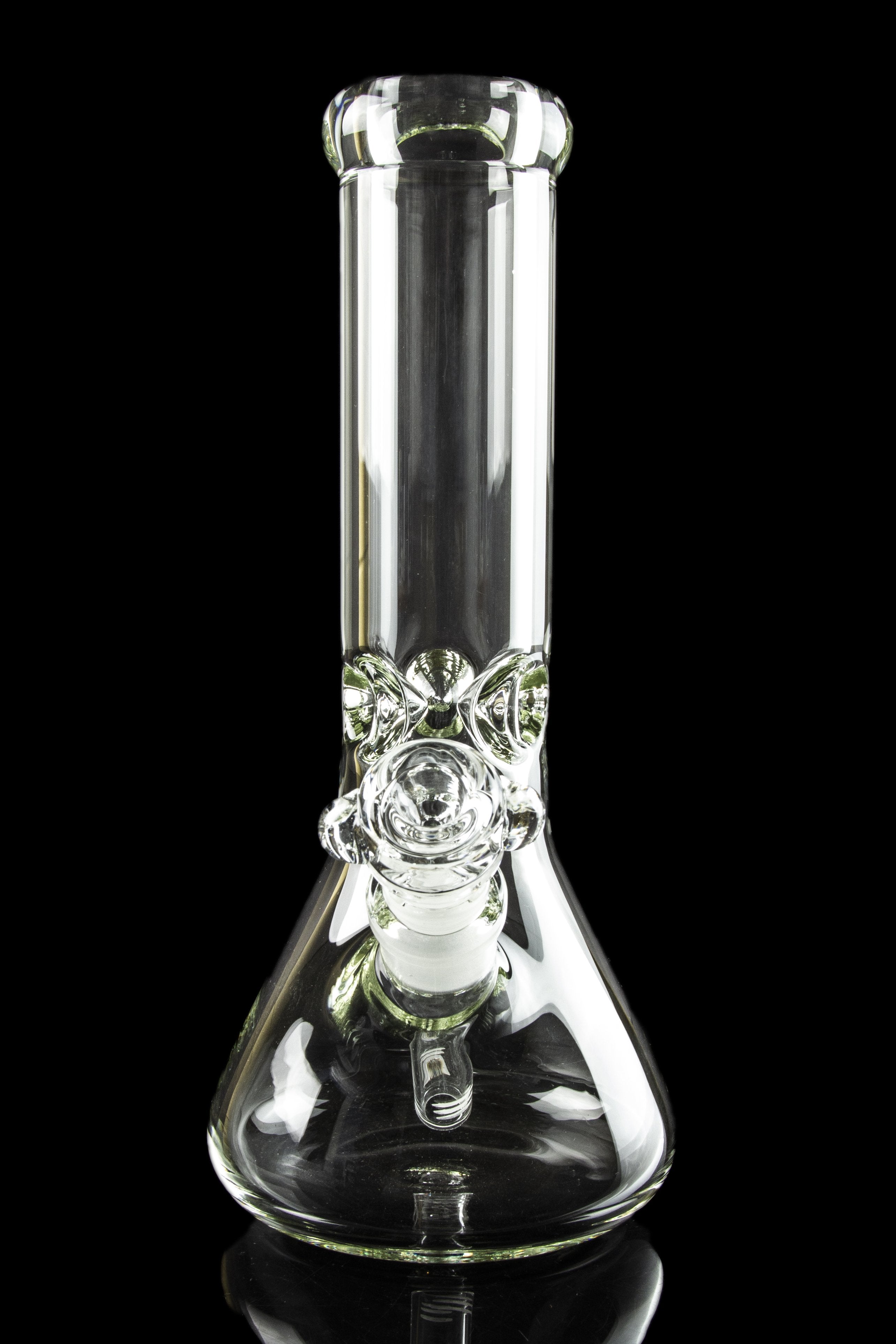 Clear glass bong with intricate detailing, reflecting on a dark surface.