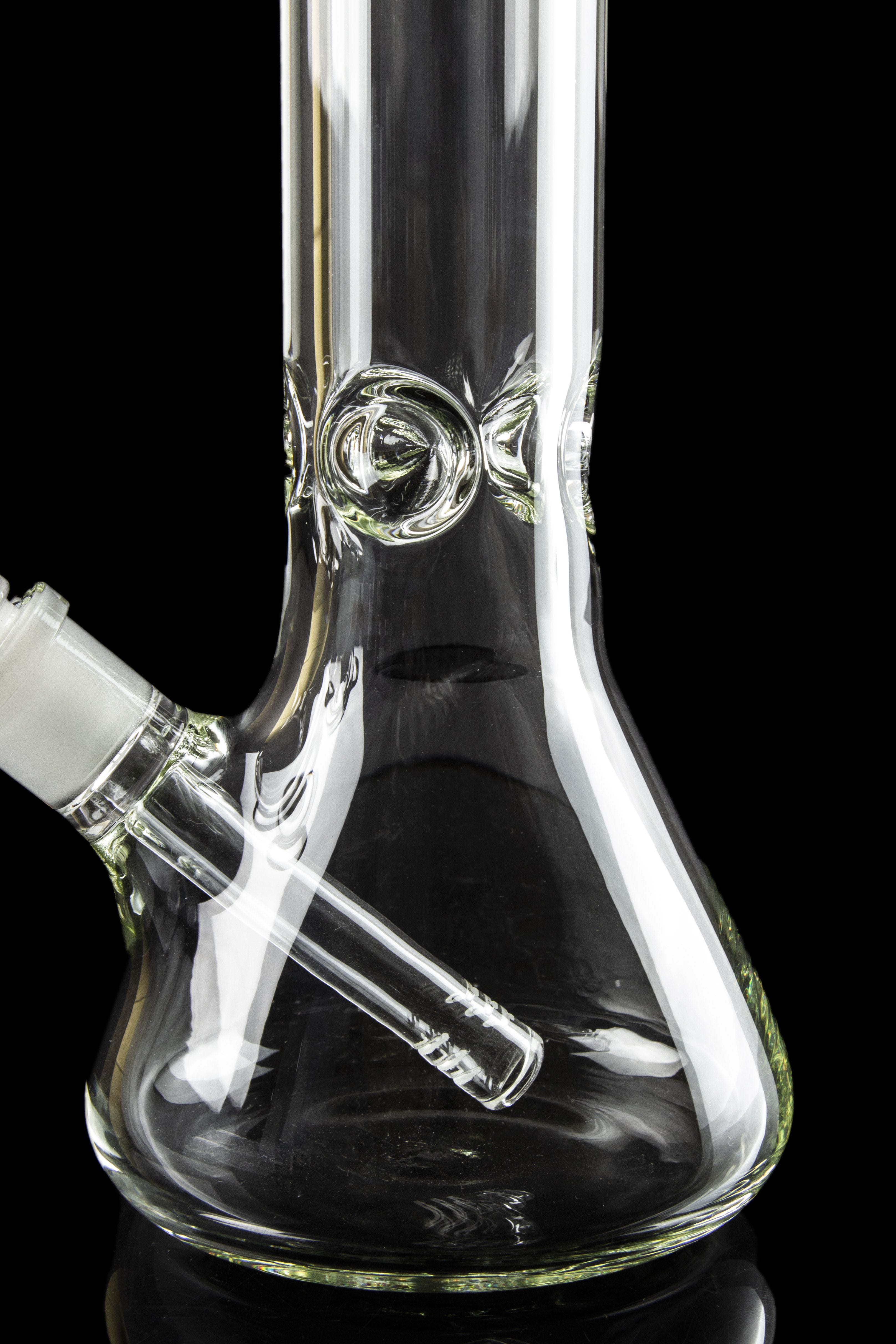 Clear glass water pipe (bong) with intricate design against a black background.