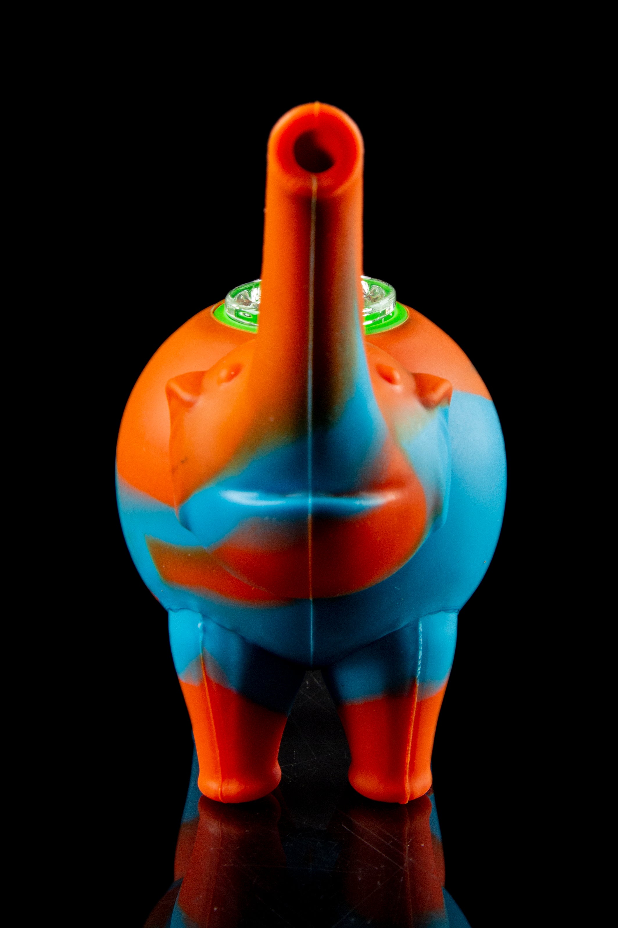 Silicone water pipe shaped like a cartoon elephant with a green glass bowl, isolated on black.