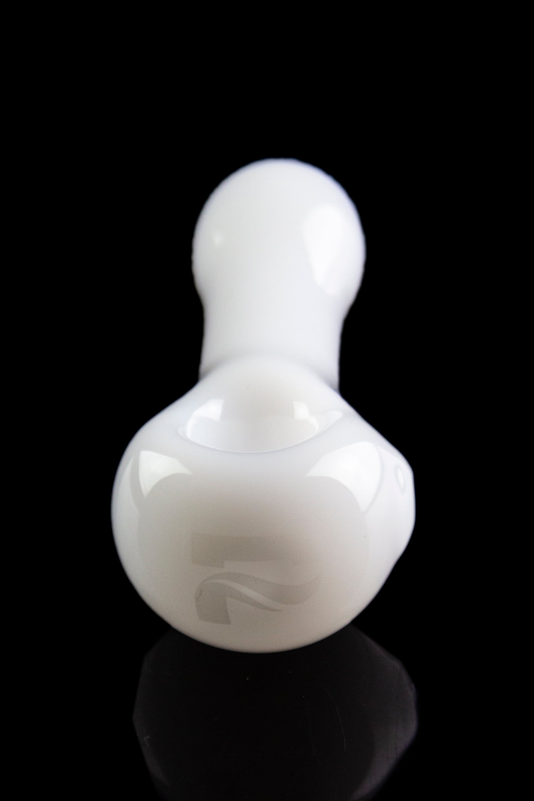 White glass bubbler with a rounded base and narrow neck, reflected on a black surface.