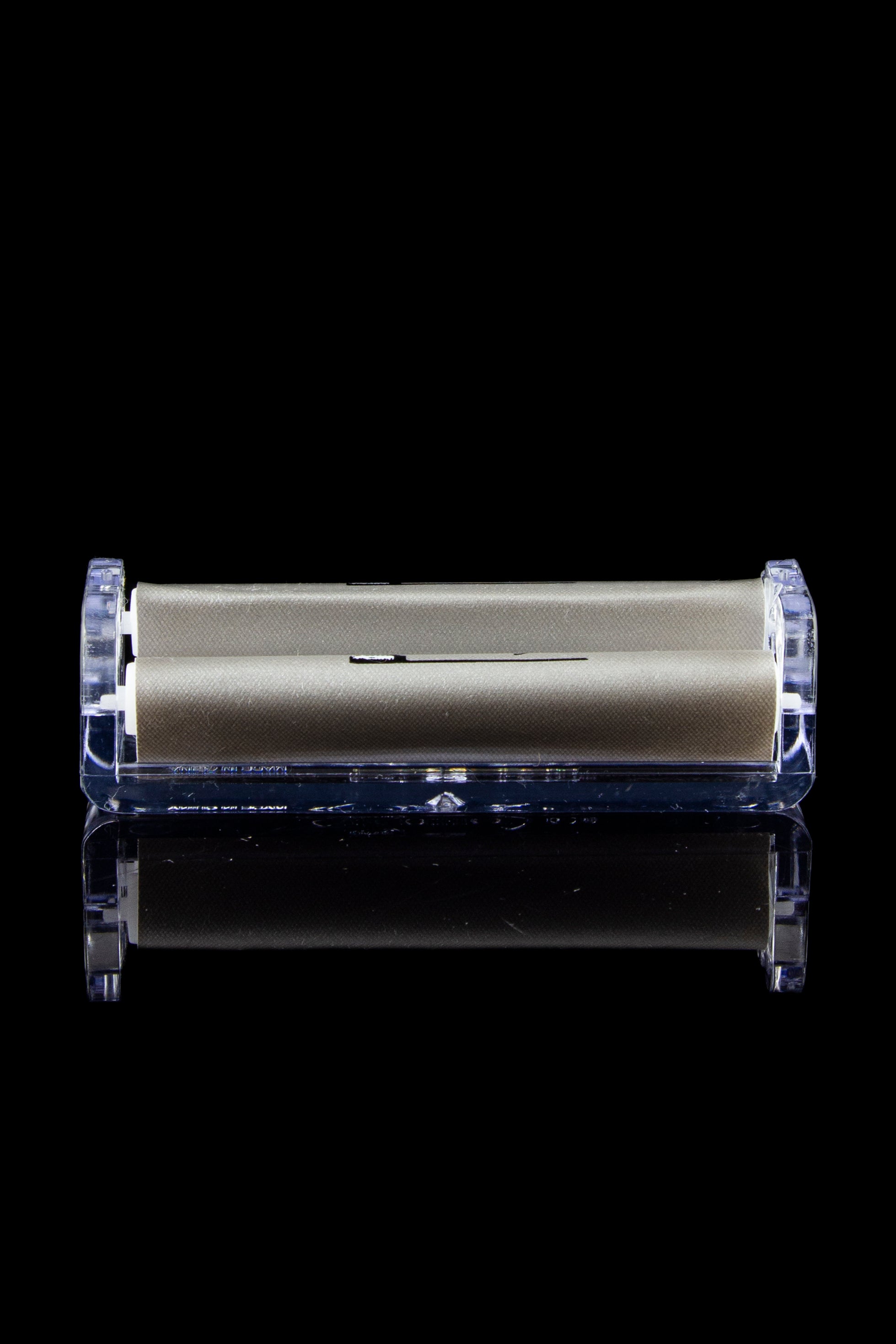 Sleek gold cannabis storage container encased in clear acrylic, with a mirrored reflection on a black surface.