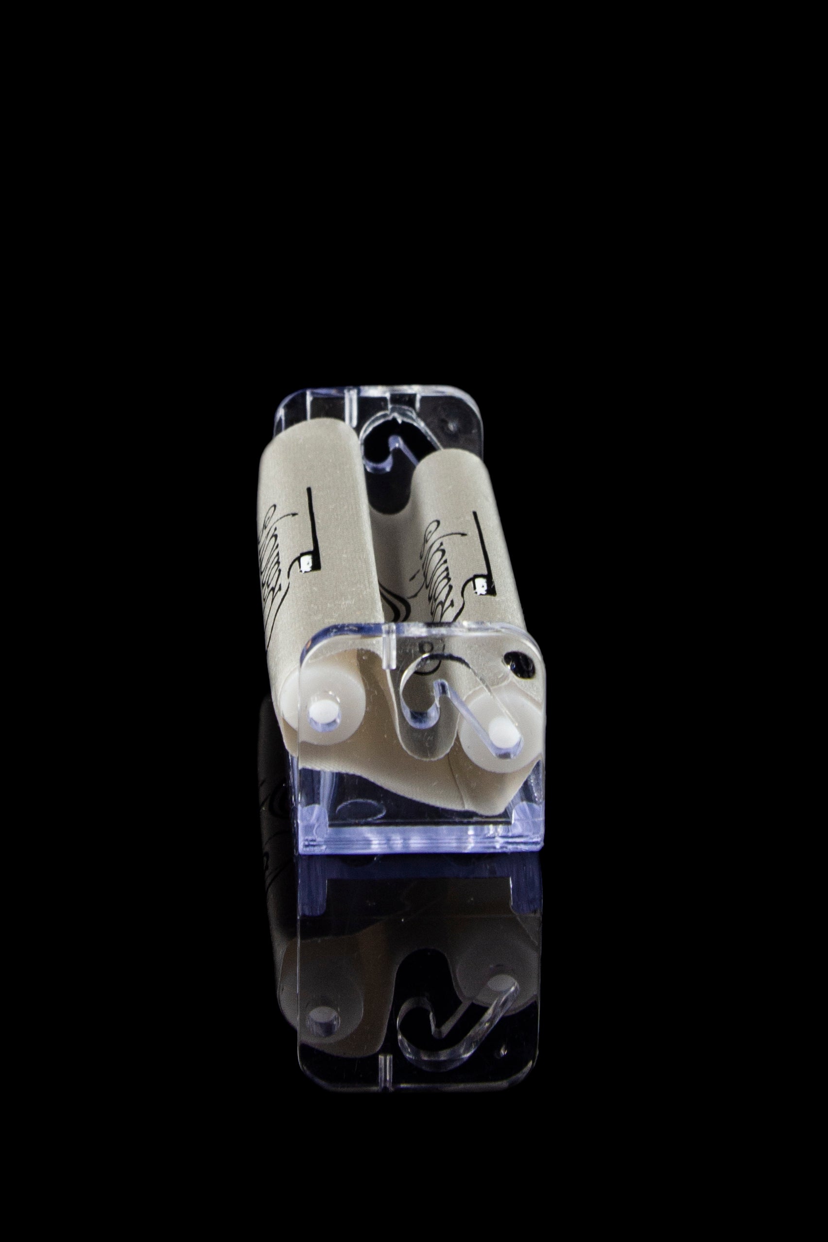 Clear acrylic container holding two pre-rolled cannabis cigarettes against a black background.