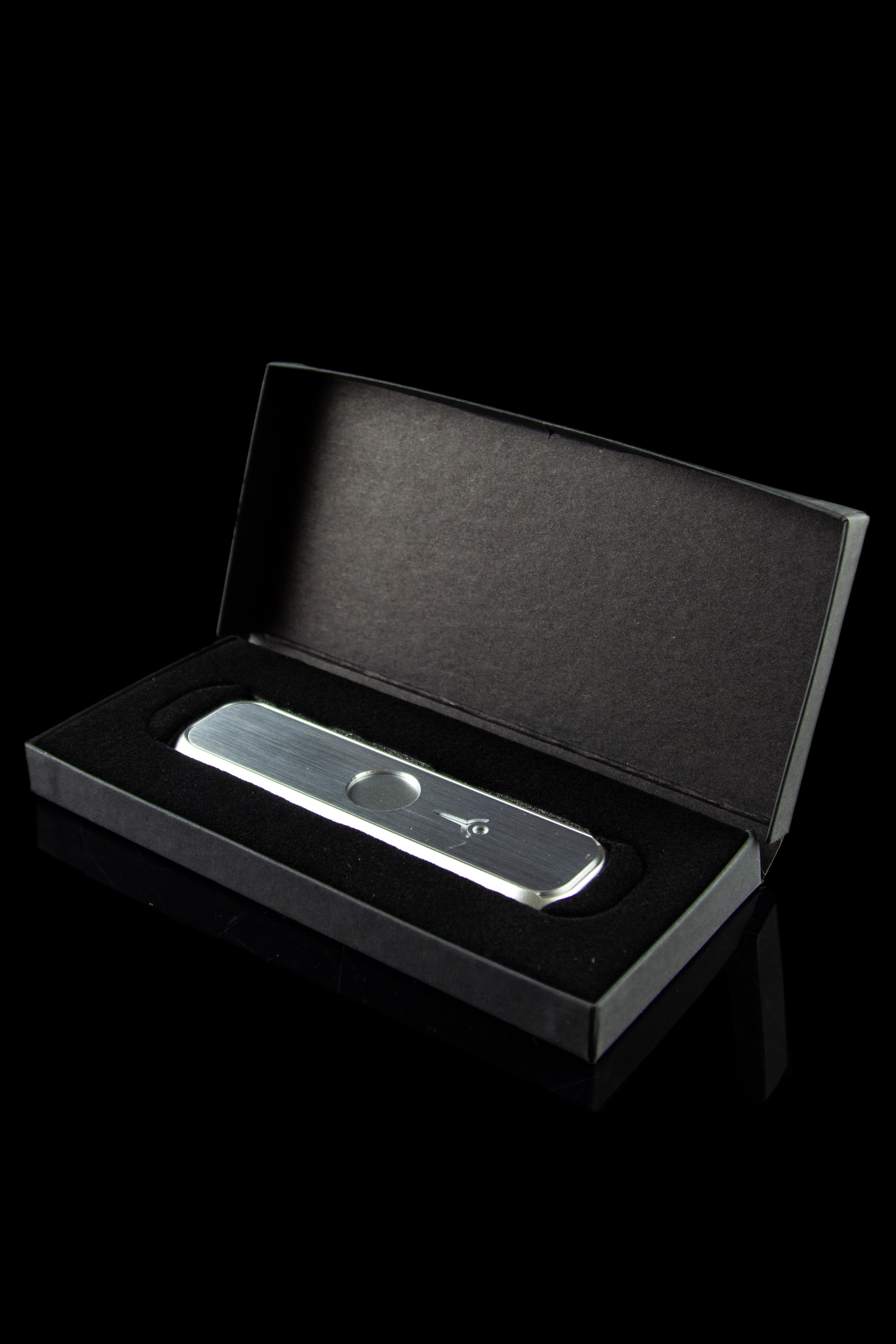 Silver cannabis oil vaporizer pen in an open black presentation box.