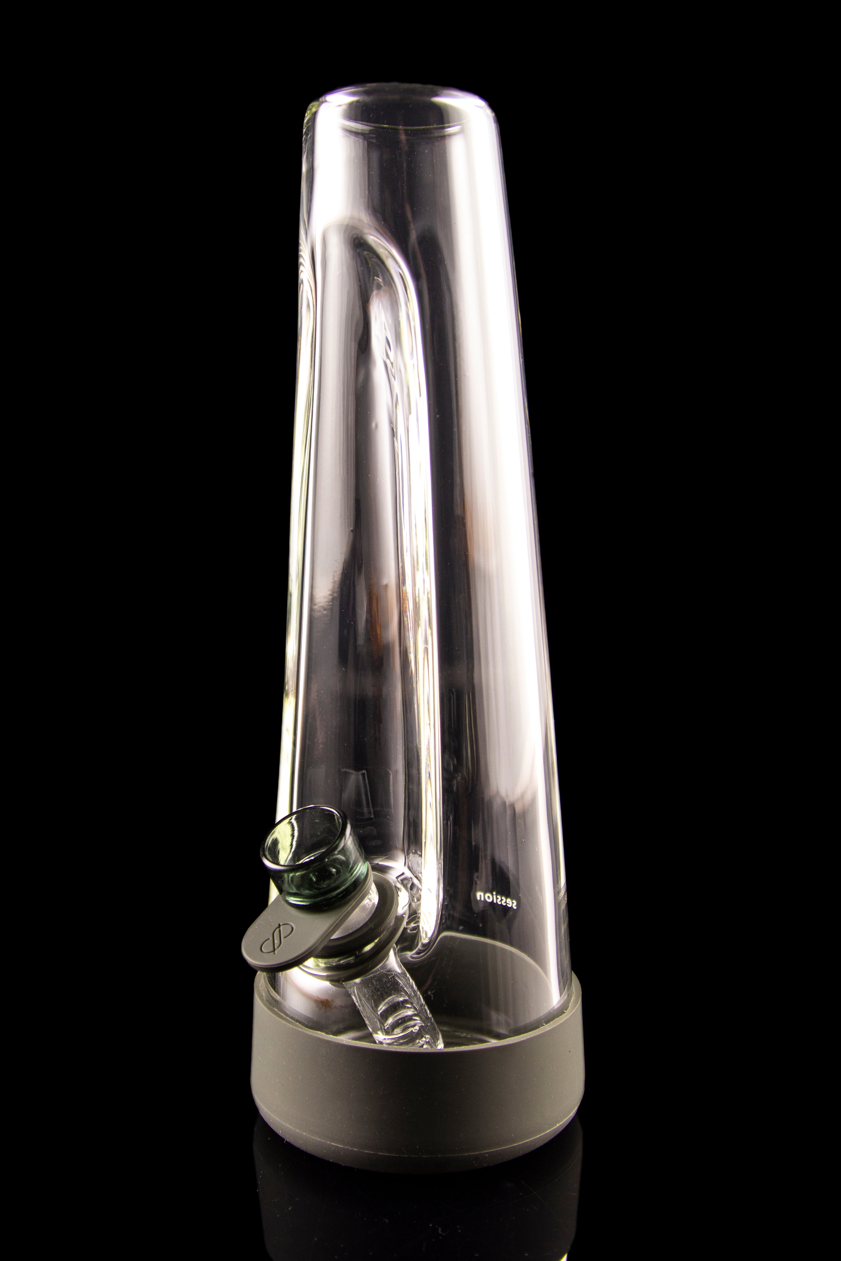 Clear glass water pipe (rig) for cannabis concentrate use, with a green mouthpiece, isolated on a black background.