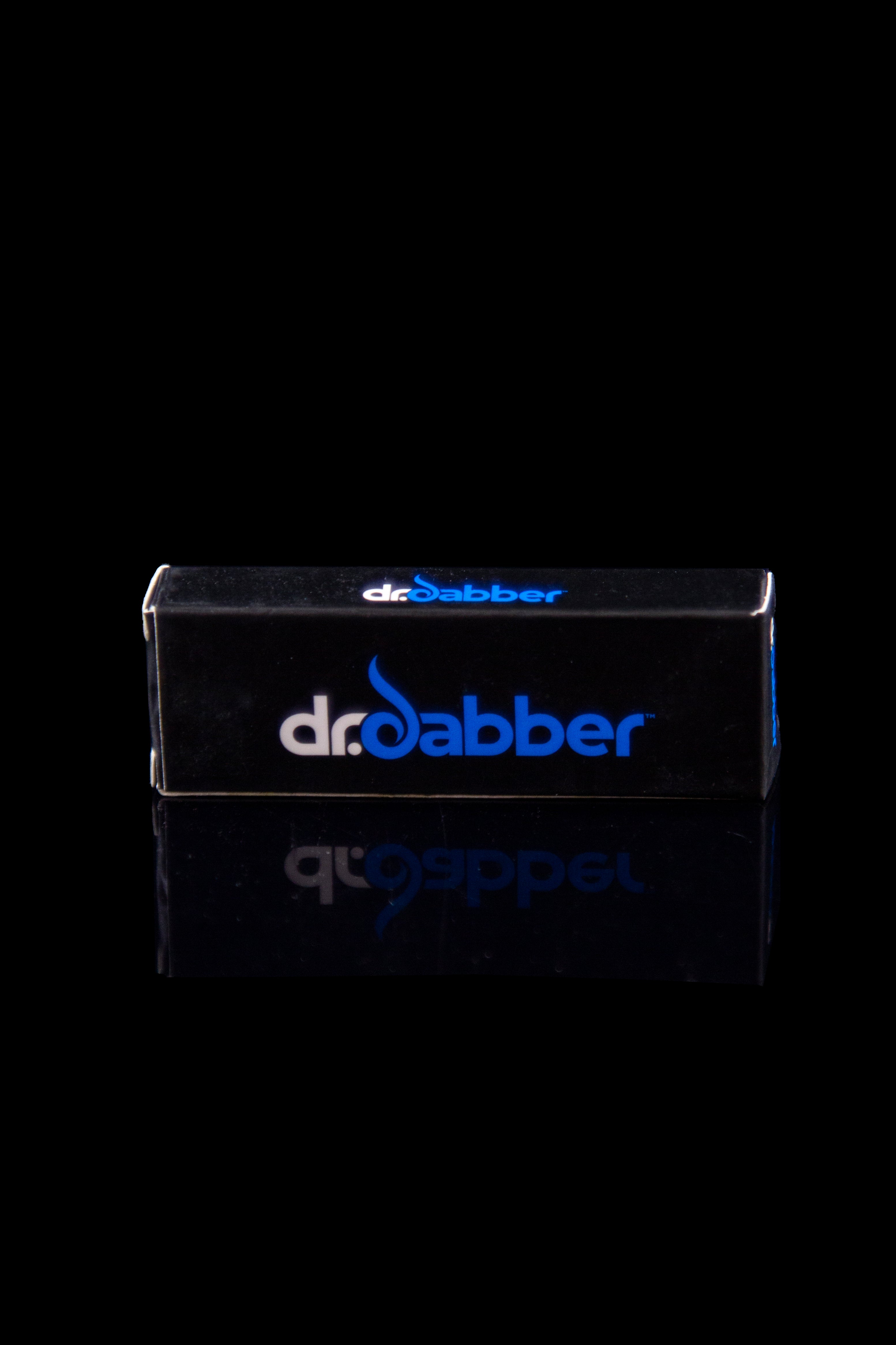 Black Dr. Dabber box with blue logo, reflecting on a dark surface.