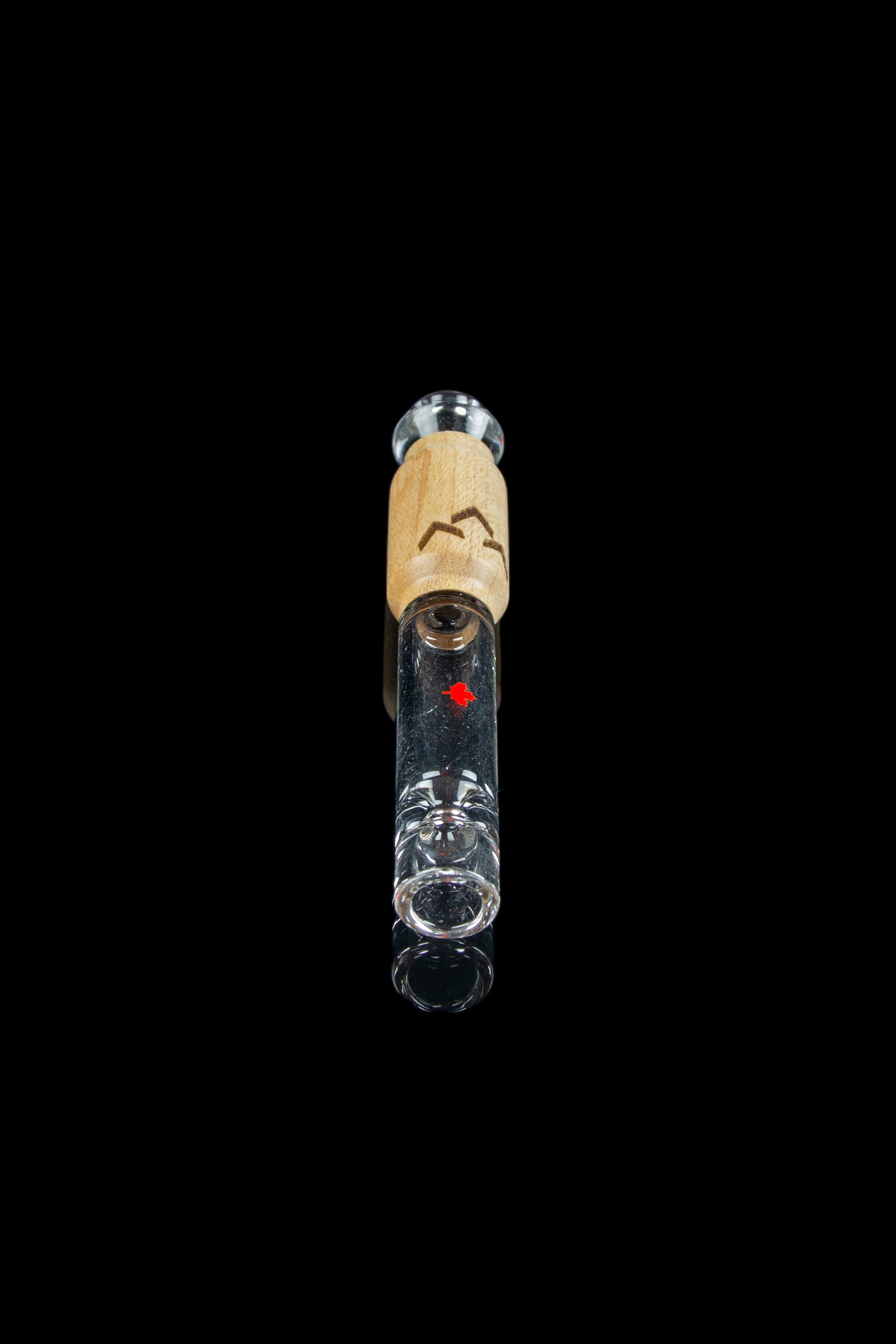 Glass oil rig with a wooden accent and visible liquid inside, isolated on a black background.