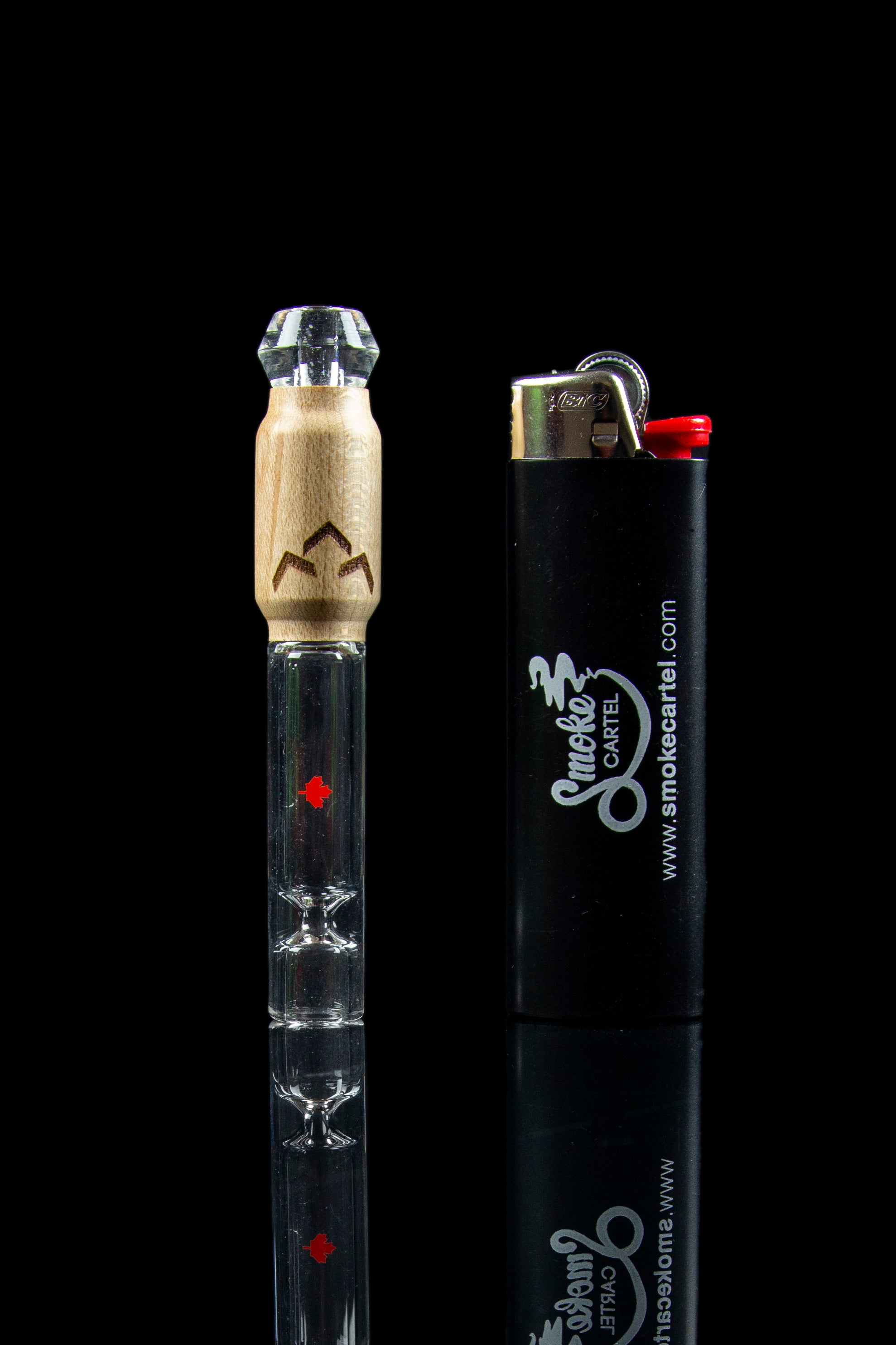 Glass cannabis pipe with a wooden mouthpiece and a black lighter displaying a cannabis leaf logo.