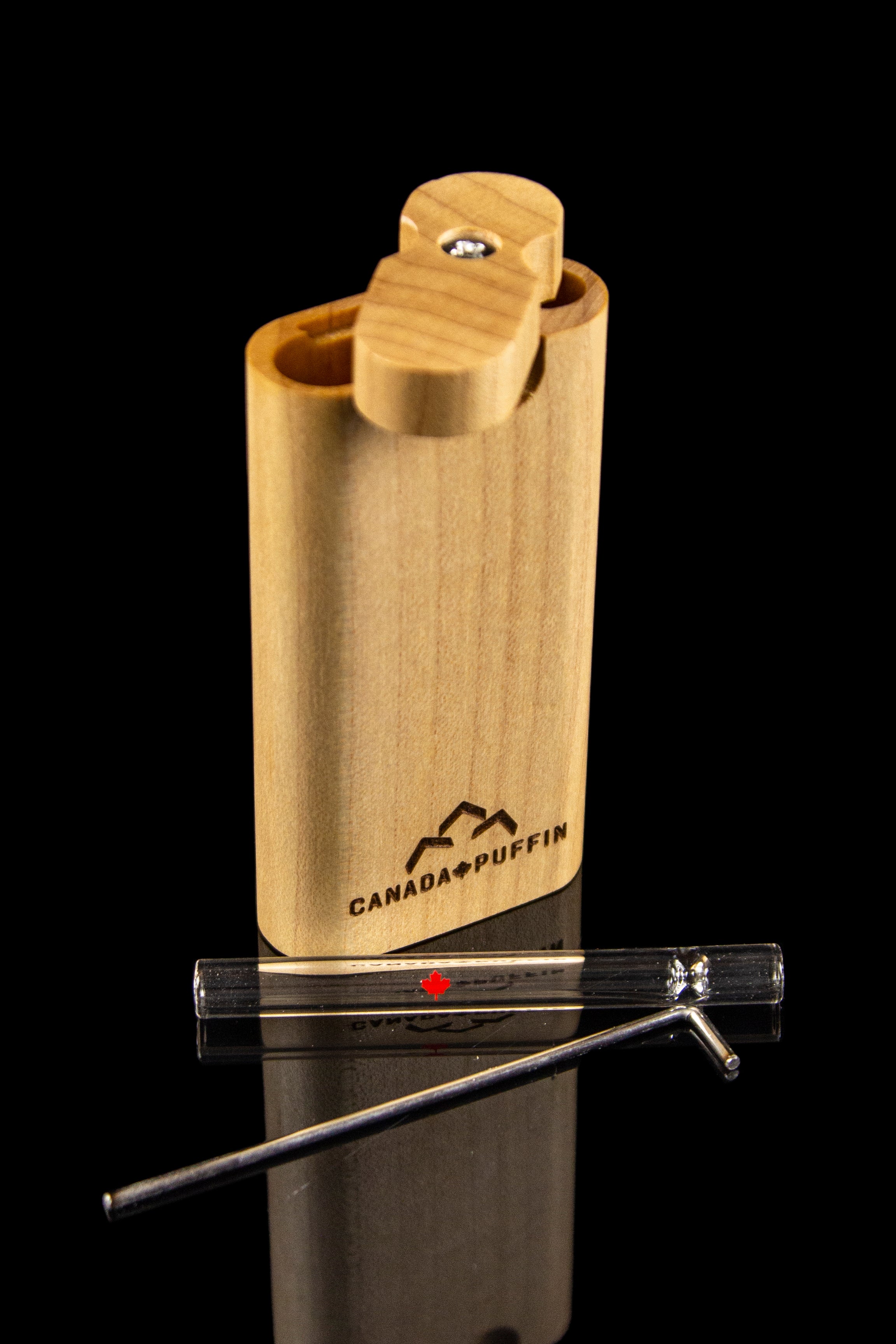 Wooden dugout with a cleaning tool and Canada Puffin logo, reflecting on a black surface.