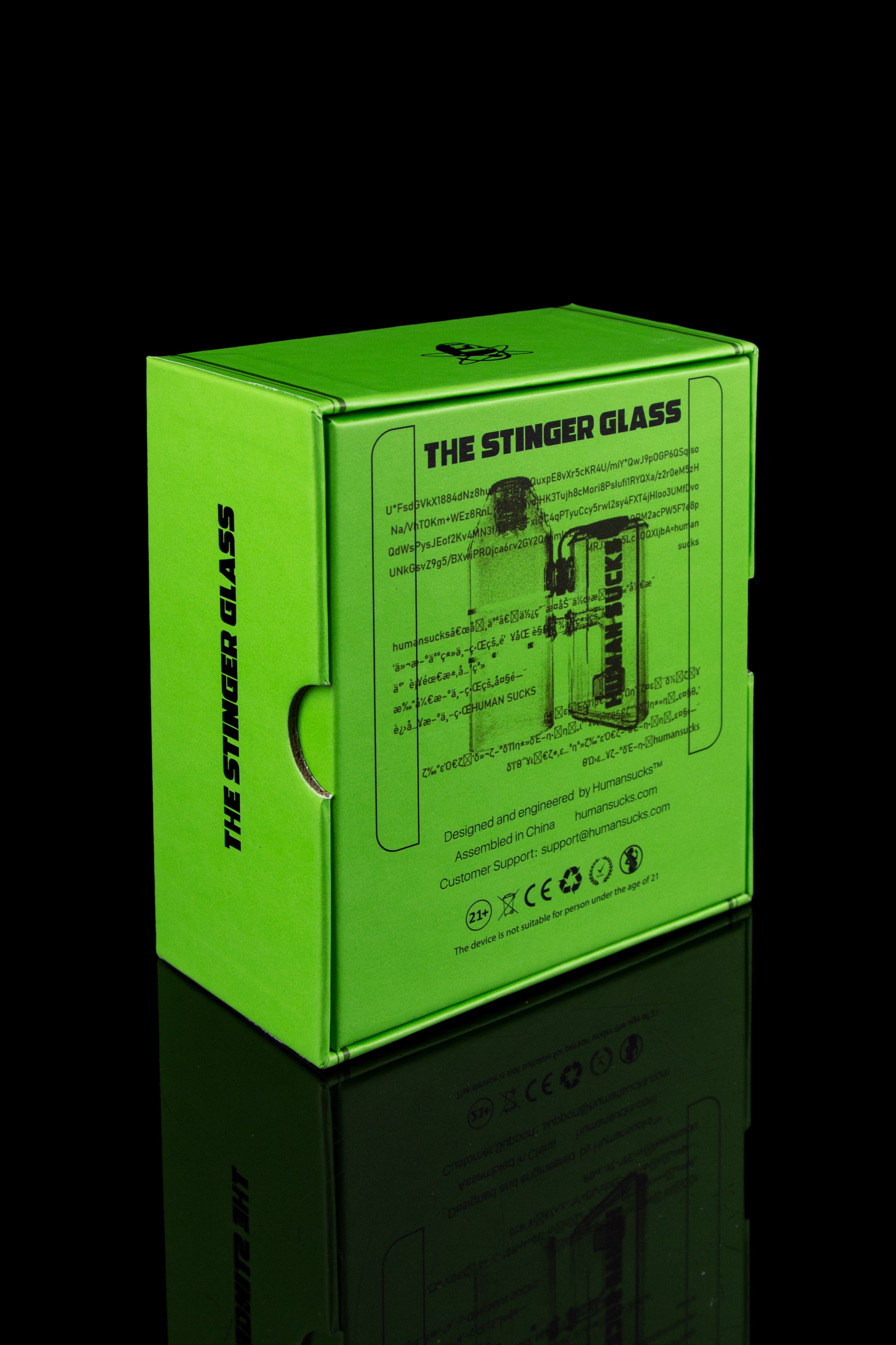 Bright green packaging box for “The Stinger Glass” cannabis accessory, displaying a repeating pattern of the brand’s logo and warning labels.