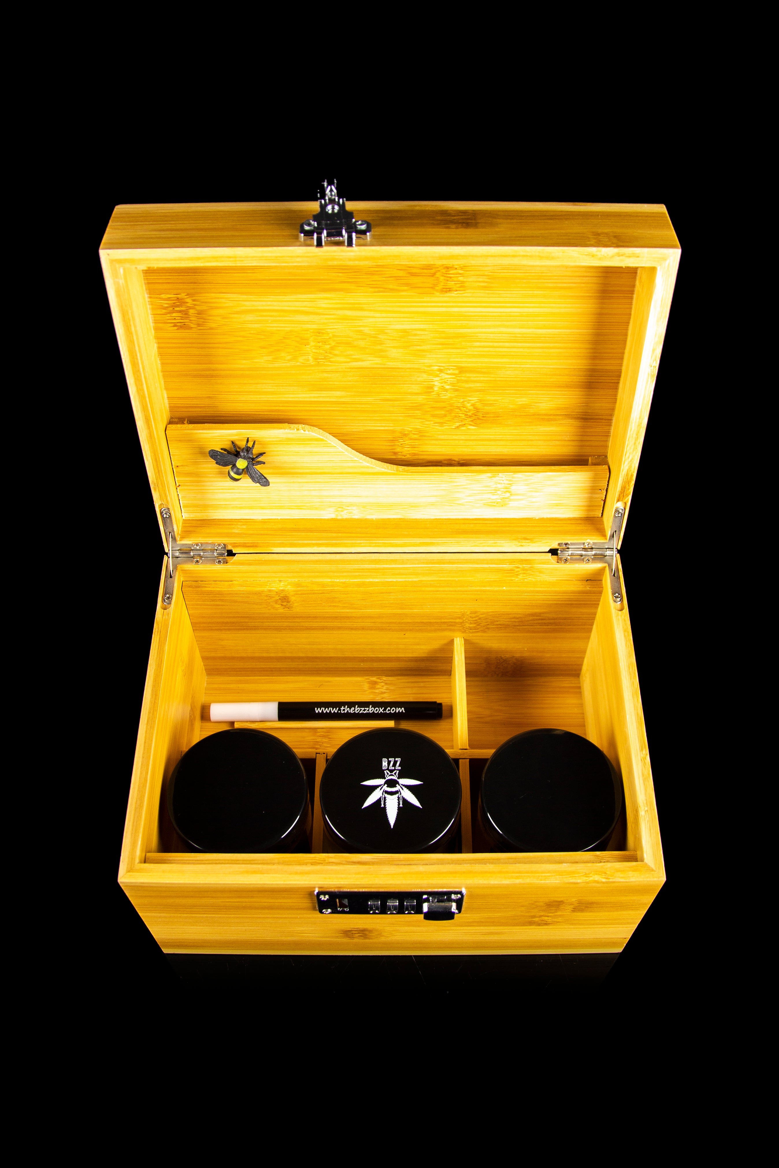 Wooden cannabis storage box with jars and accessories inside.