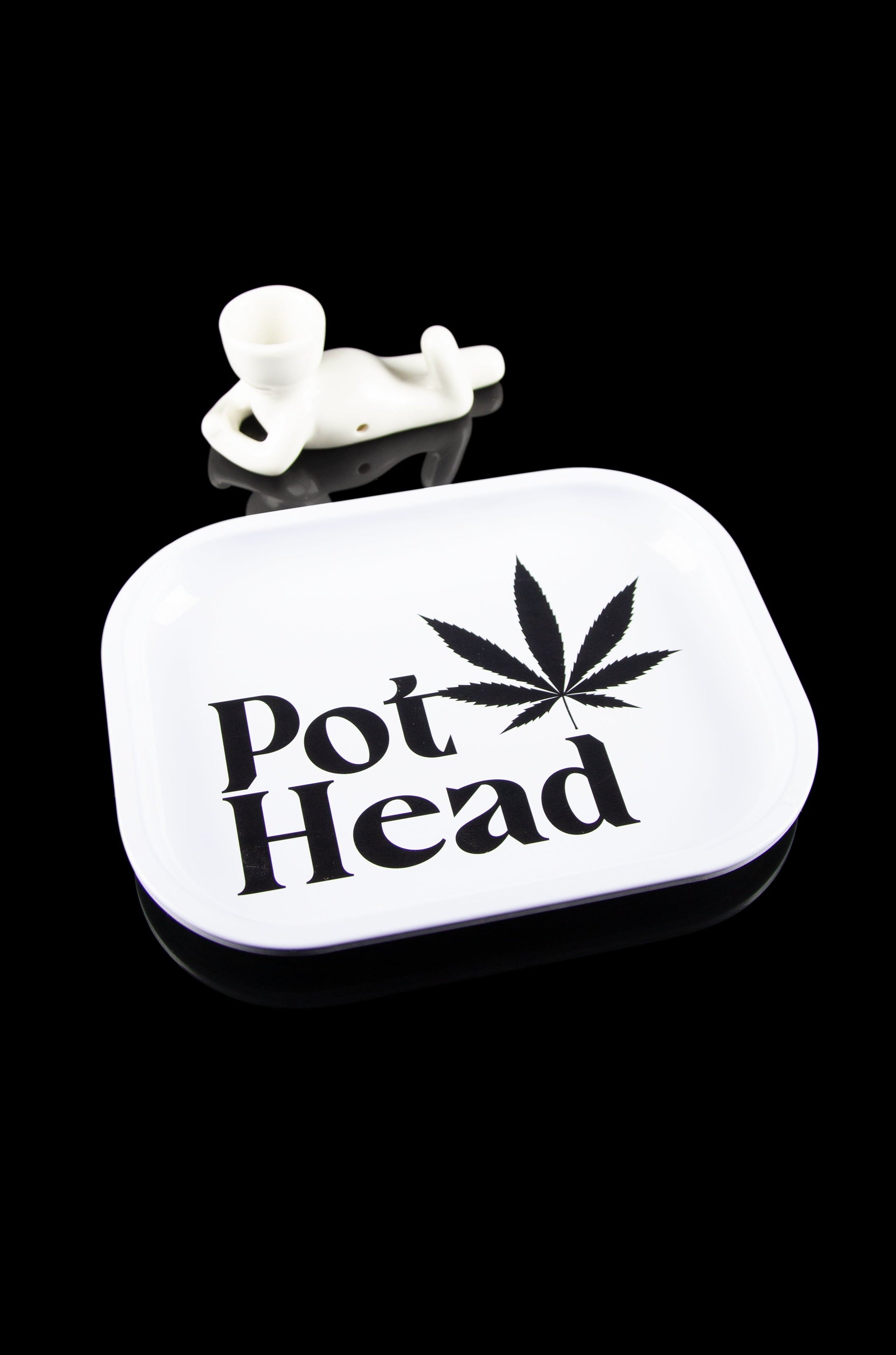 A white tin container labeled "Pot Head" with a cannabis leaf design and a small, white skull-shaped accessory on top, set against a black background.