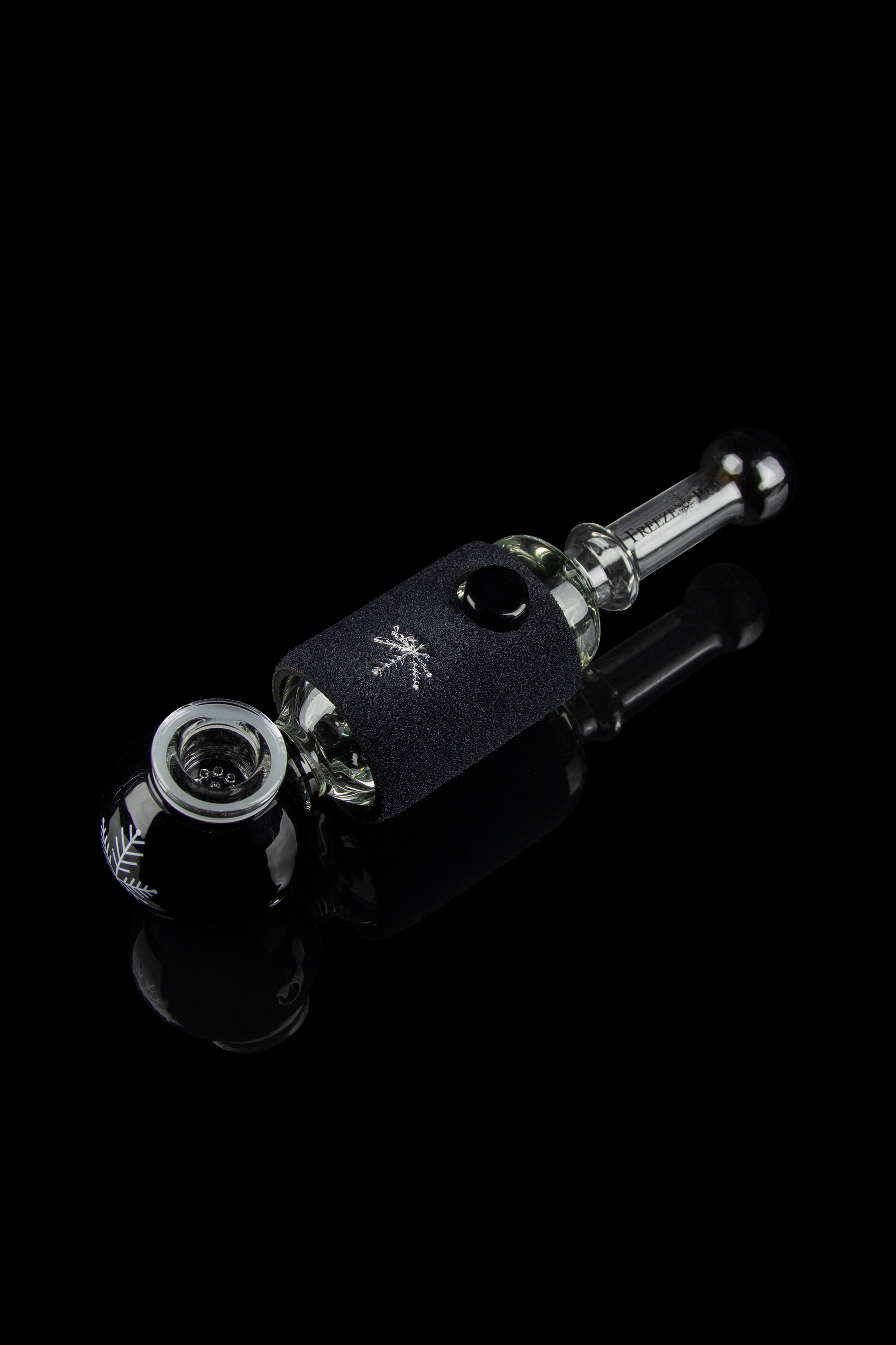 Glass pipe with black, textured wrap and reflective surface, studio shot.