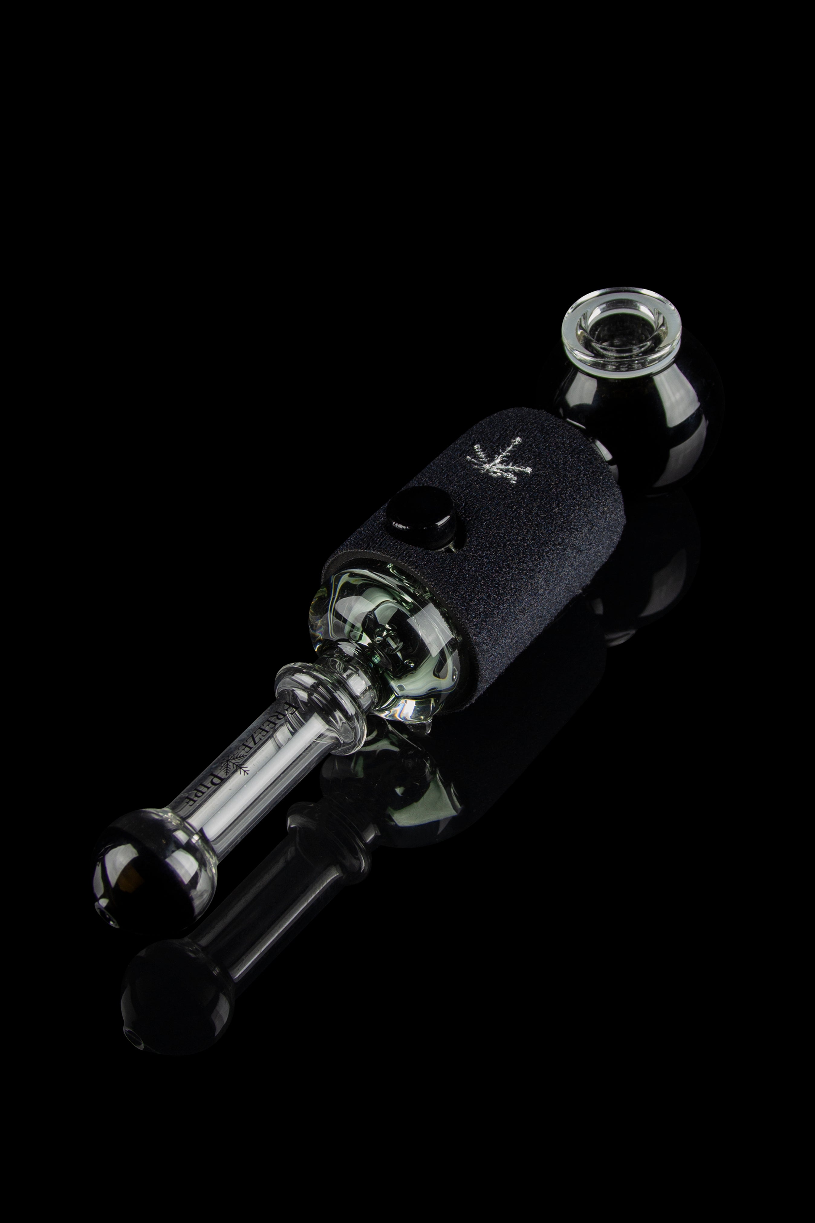 Black glass oil rig with a textured sleeve, illuminated against a dark reflective surface.