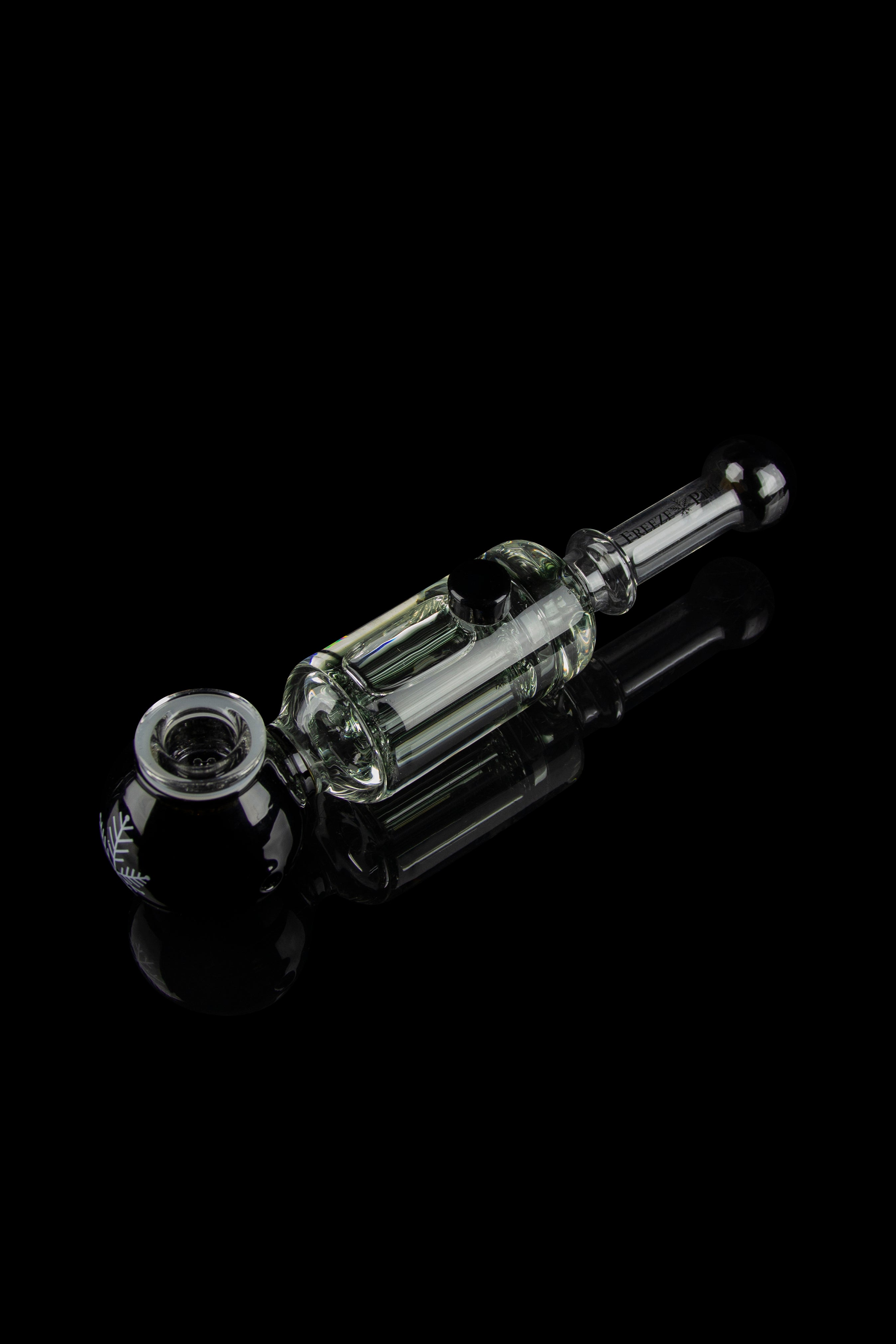 Clear glass rig with intricate bubbler design, isolated on a reflective black surface.