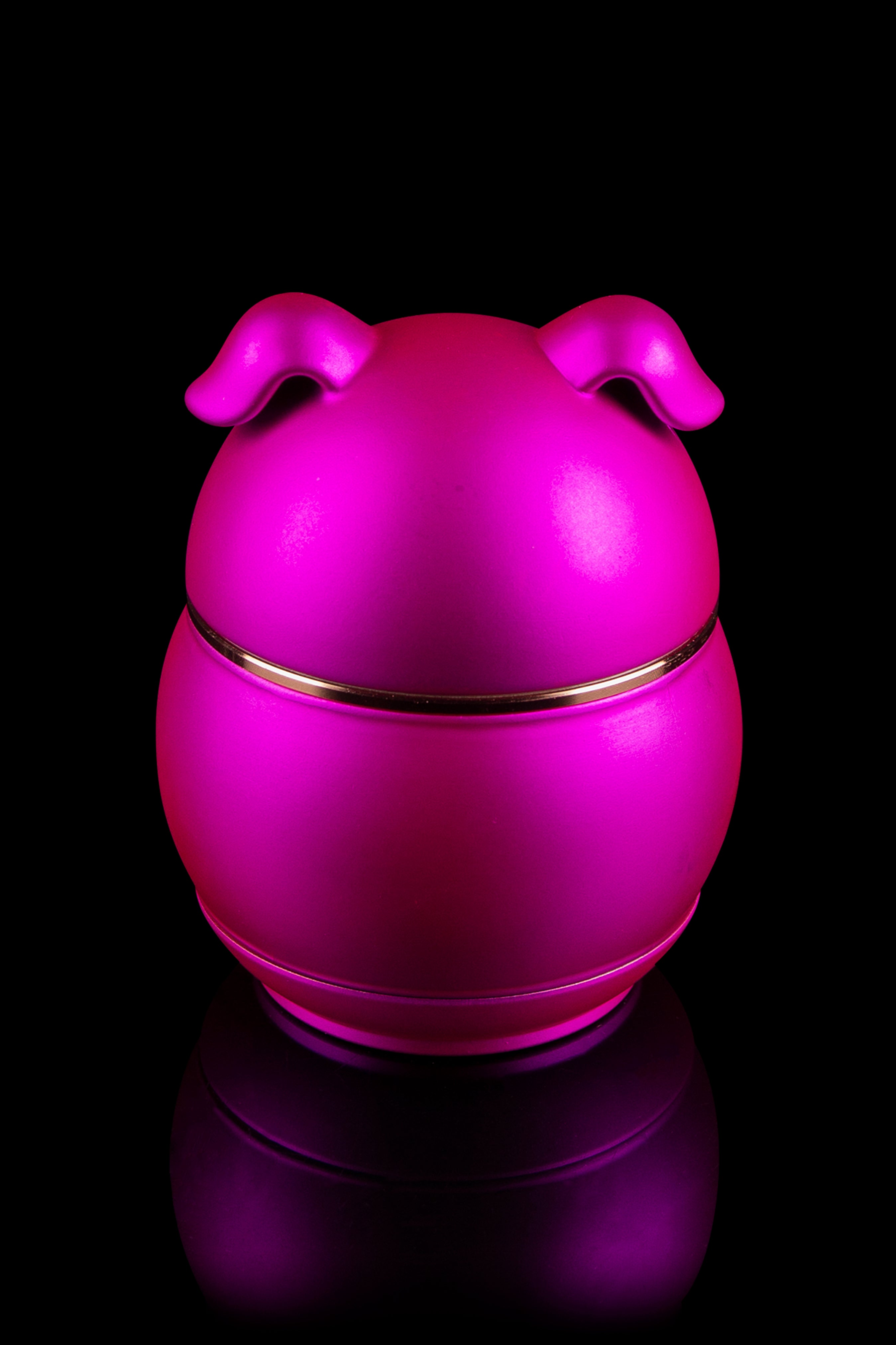 Bright pink silicone cannabis concentrate container with reflective base.